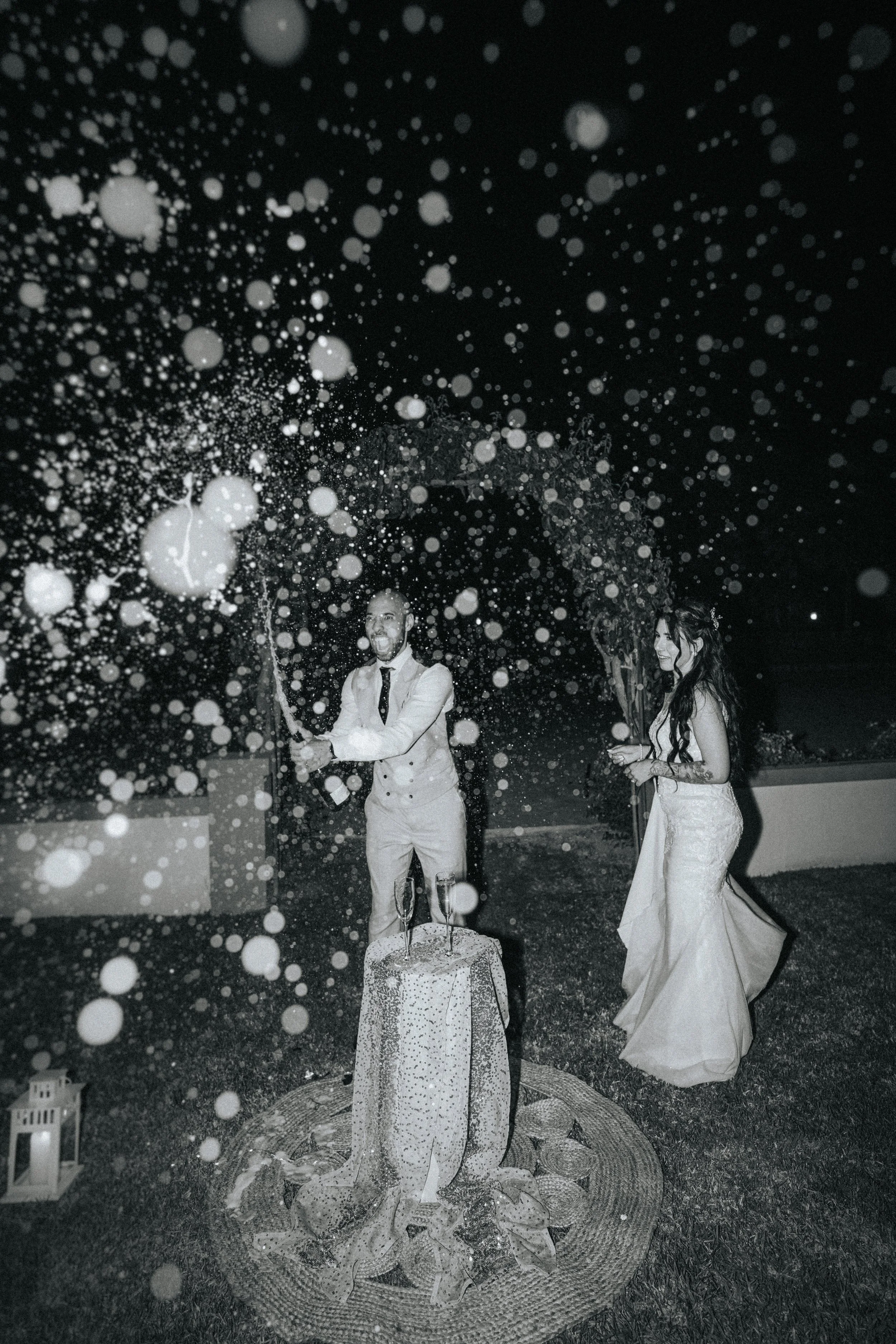 Bride and groom opening champagne