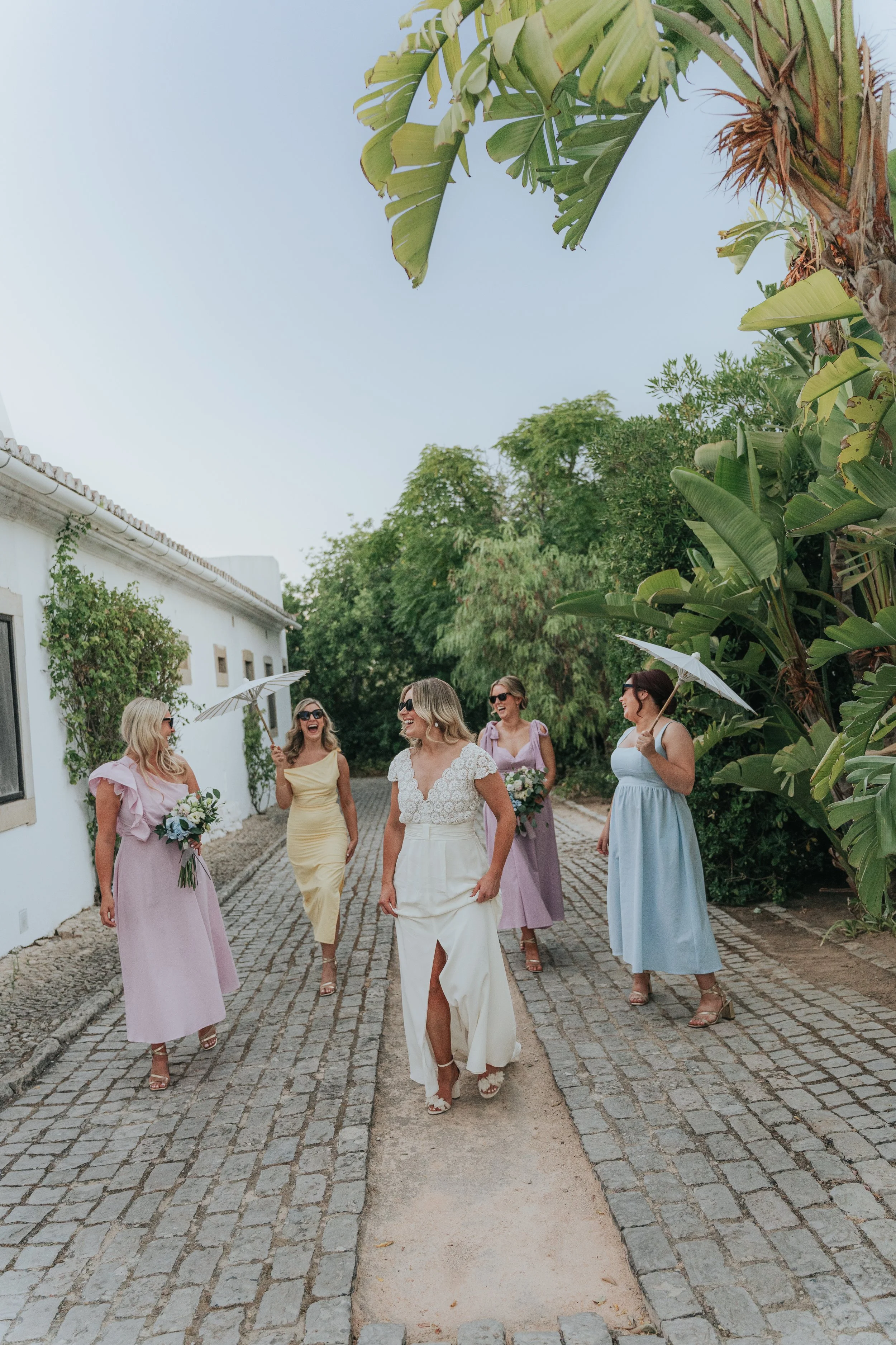 Happy bride with her bridesmaids at Os Agostos wedding venue