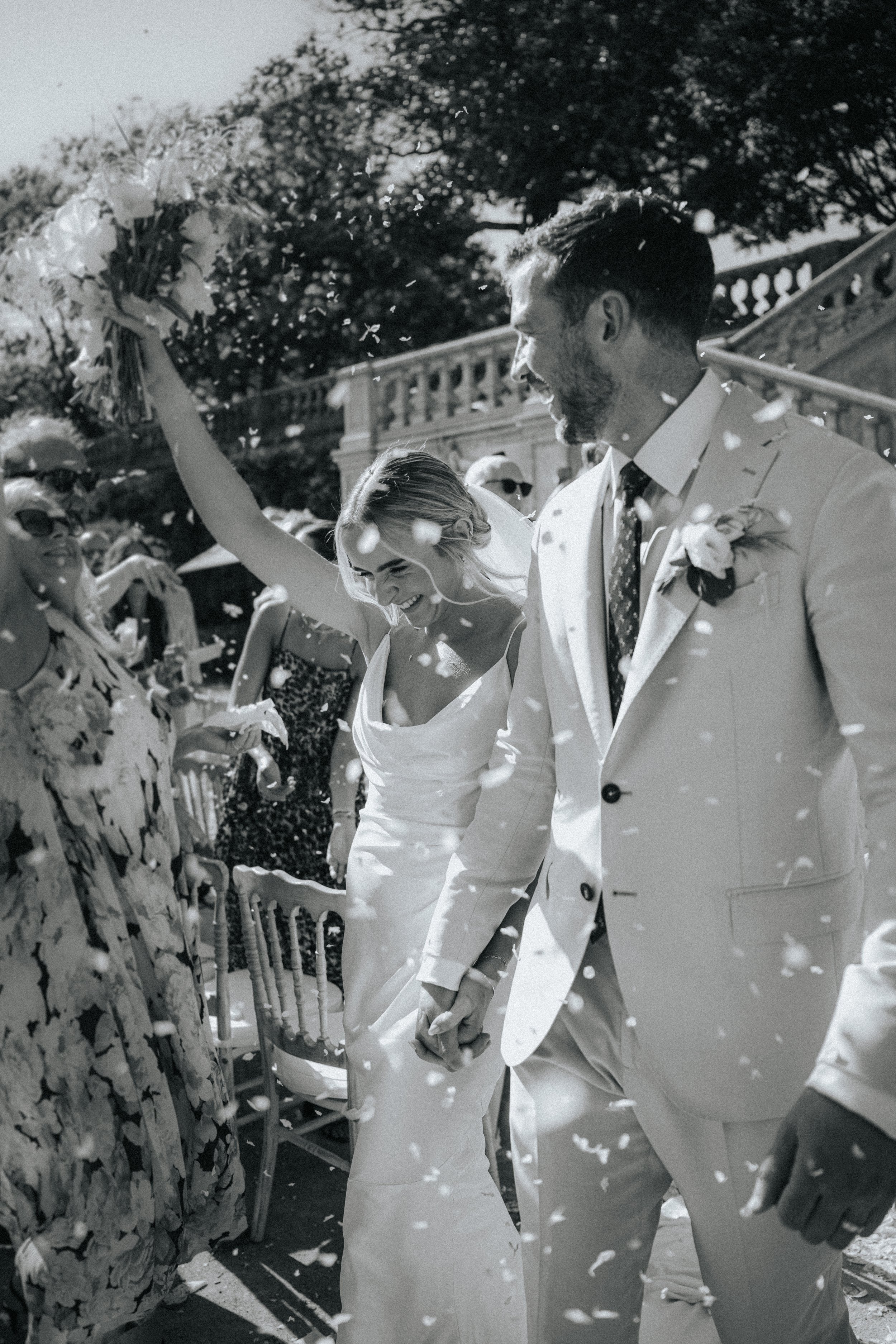 Bride and groom leaving the ceremony with flower petals at Vandelli Botanical Garden in Lisbon
