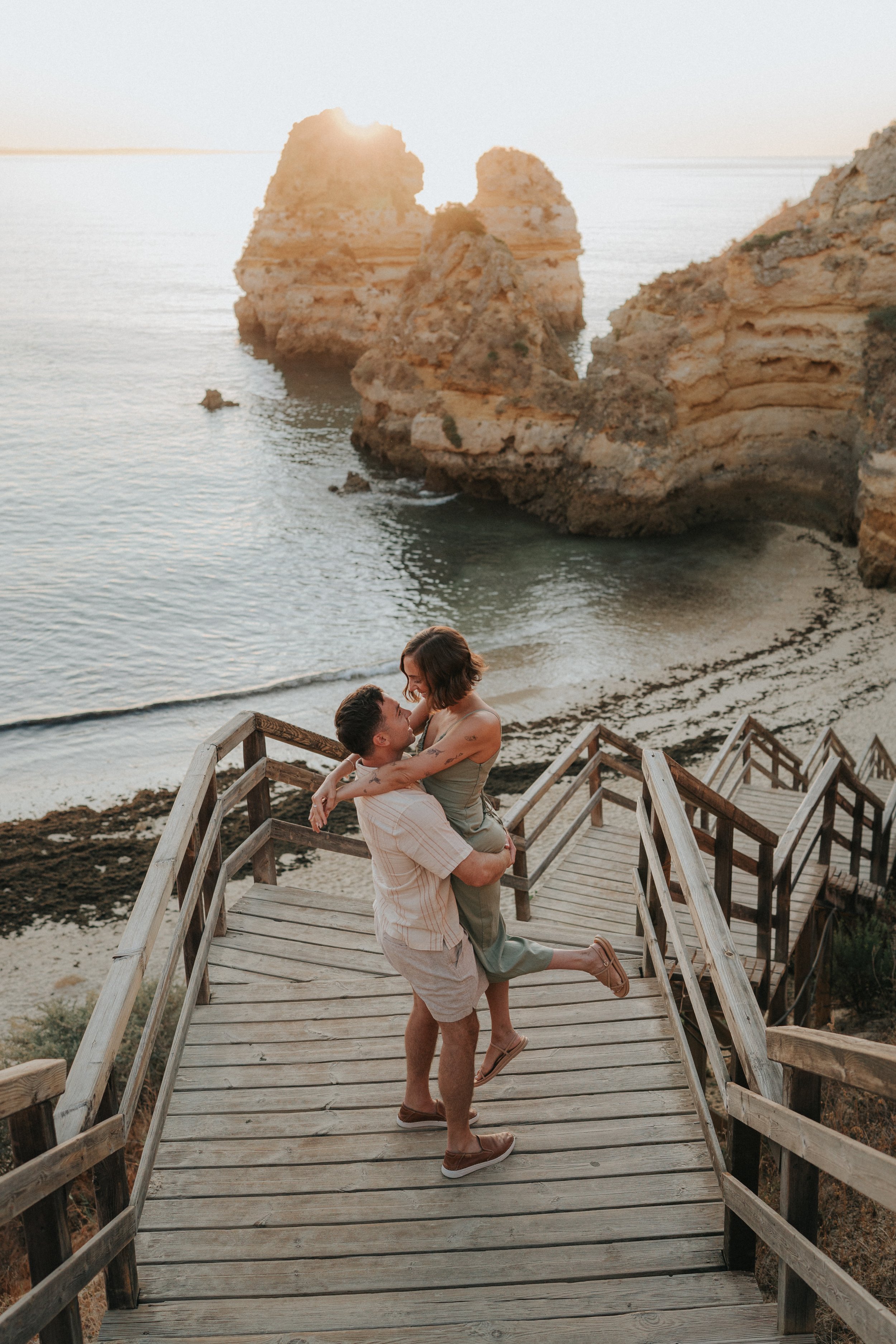 Couple hugging at sunrise at Praia do Camilo
