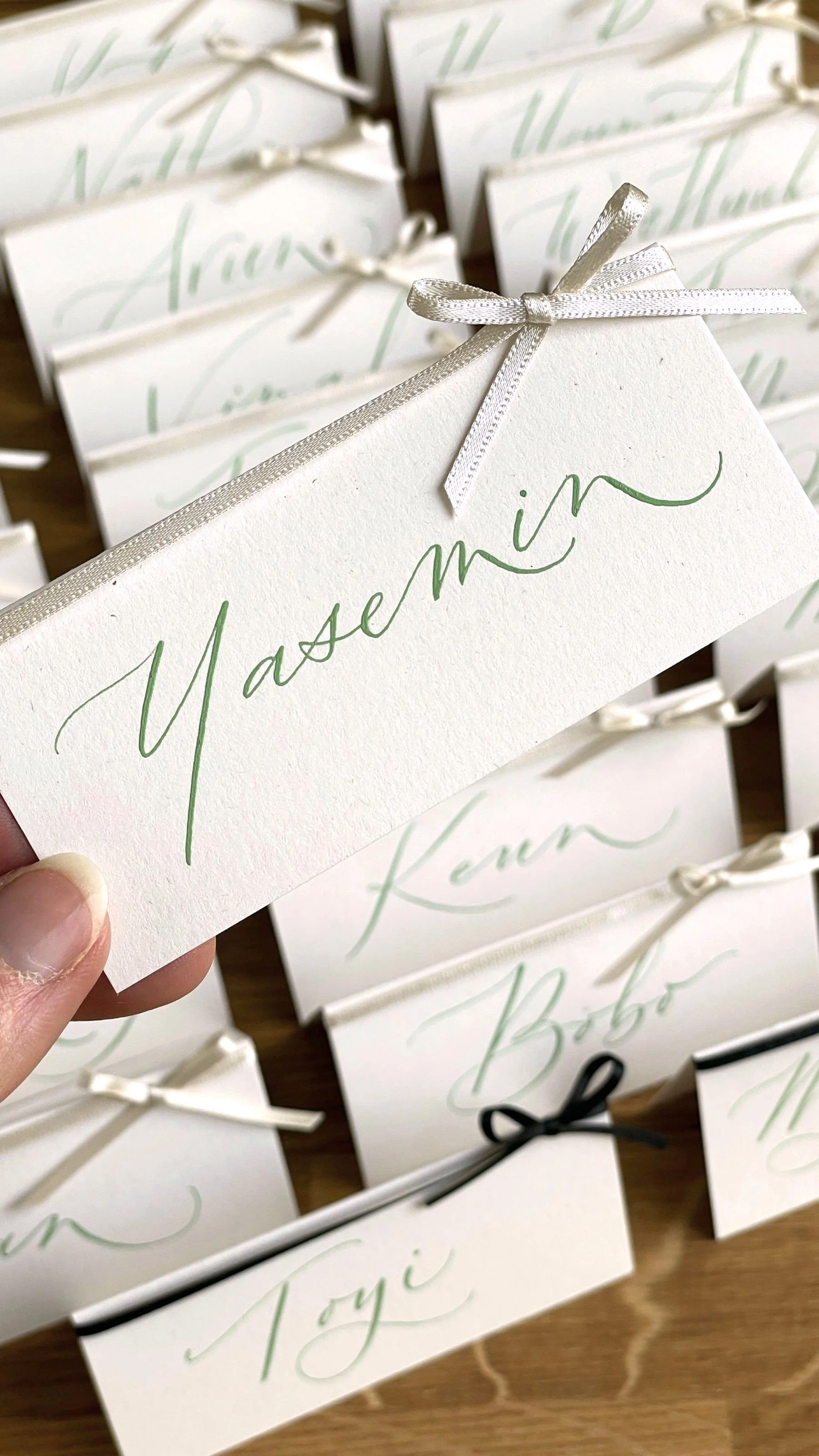 Pointed pen modern calligraphy name cards finished with bow.jpg