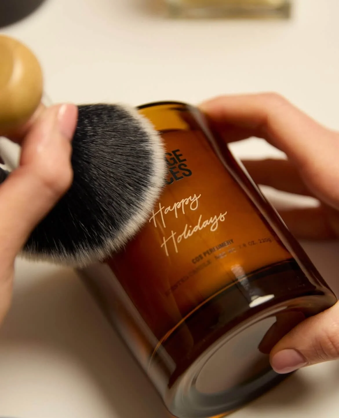 Live engraving Happy Holidays on a COS candle Christmas gift