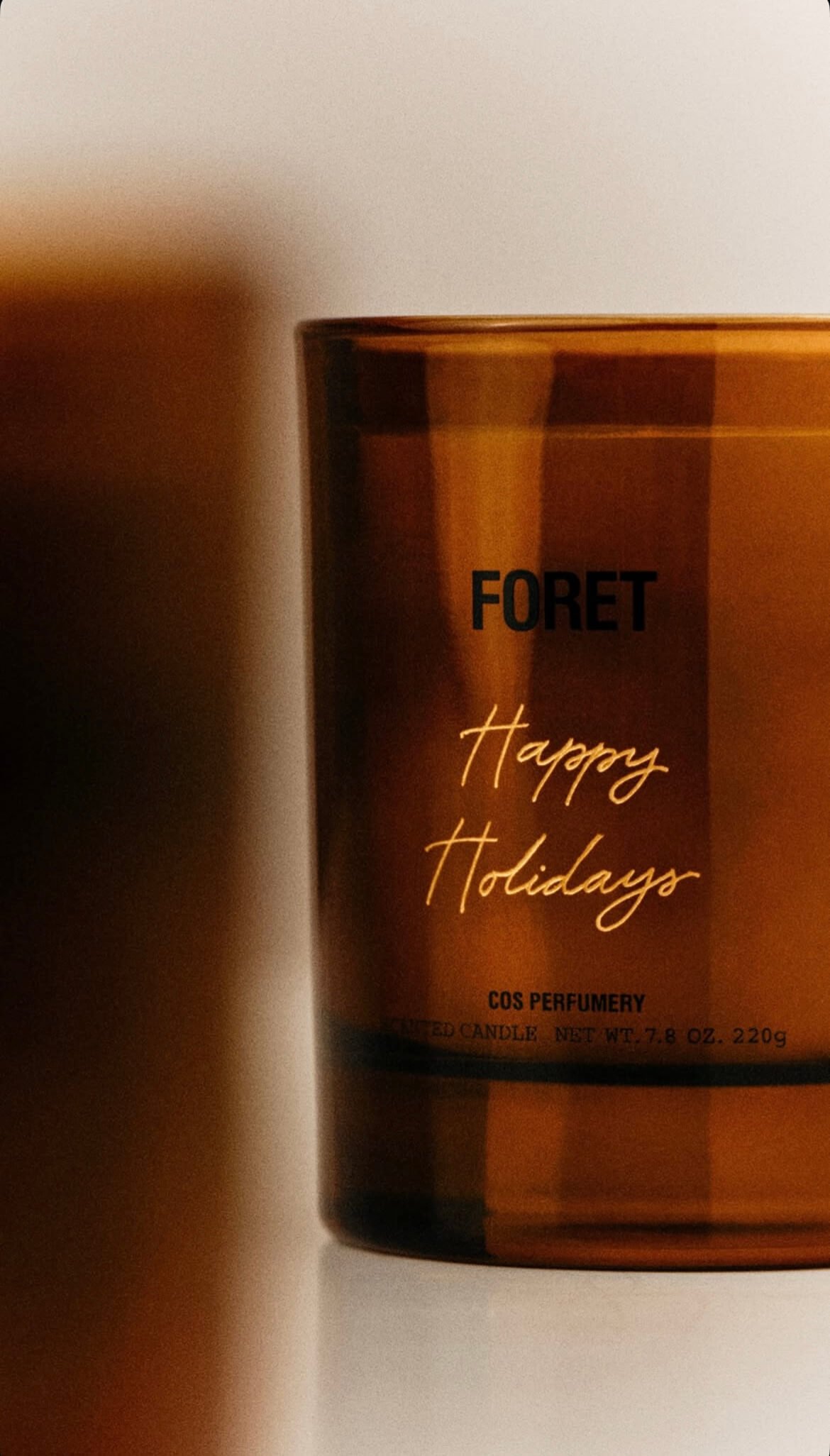 Happy Holidays hand engraved on a brown Foret COS candle
