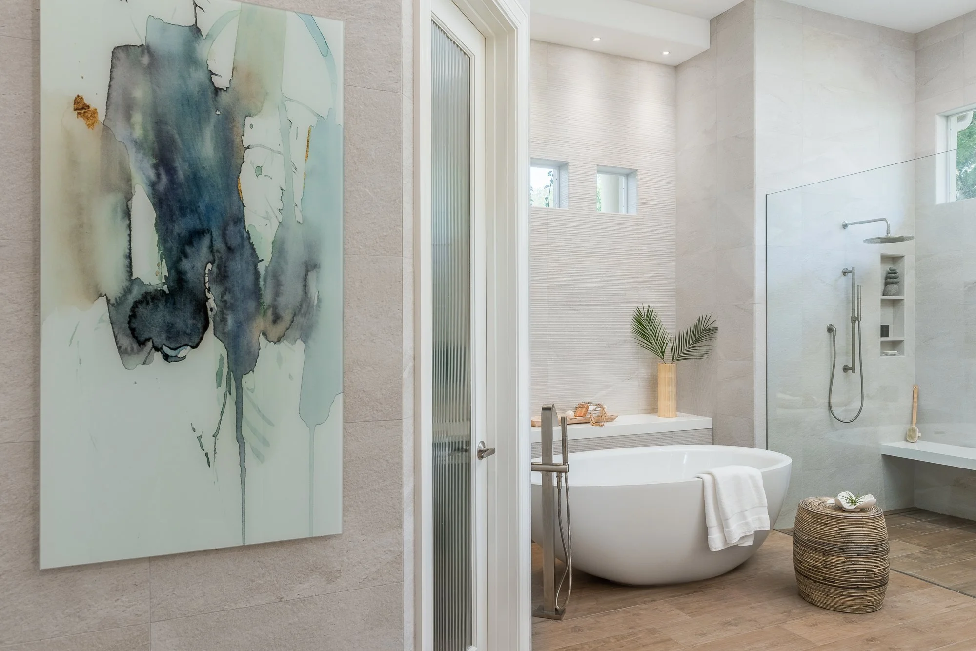 a beautiful primary bathroom in Tampa, that features a stone resin freestanding tub, remodeled by Lindross Remodeling