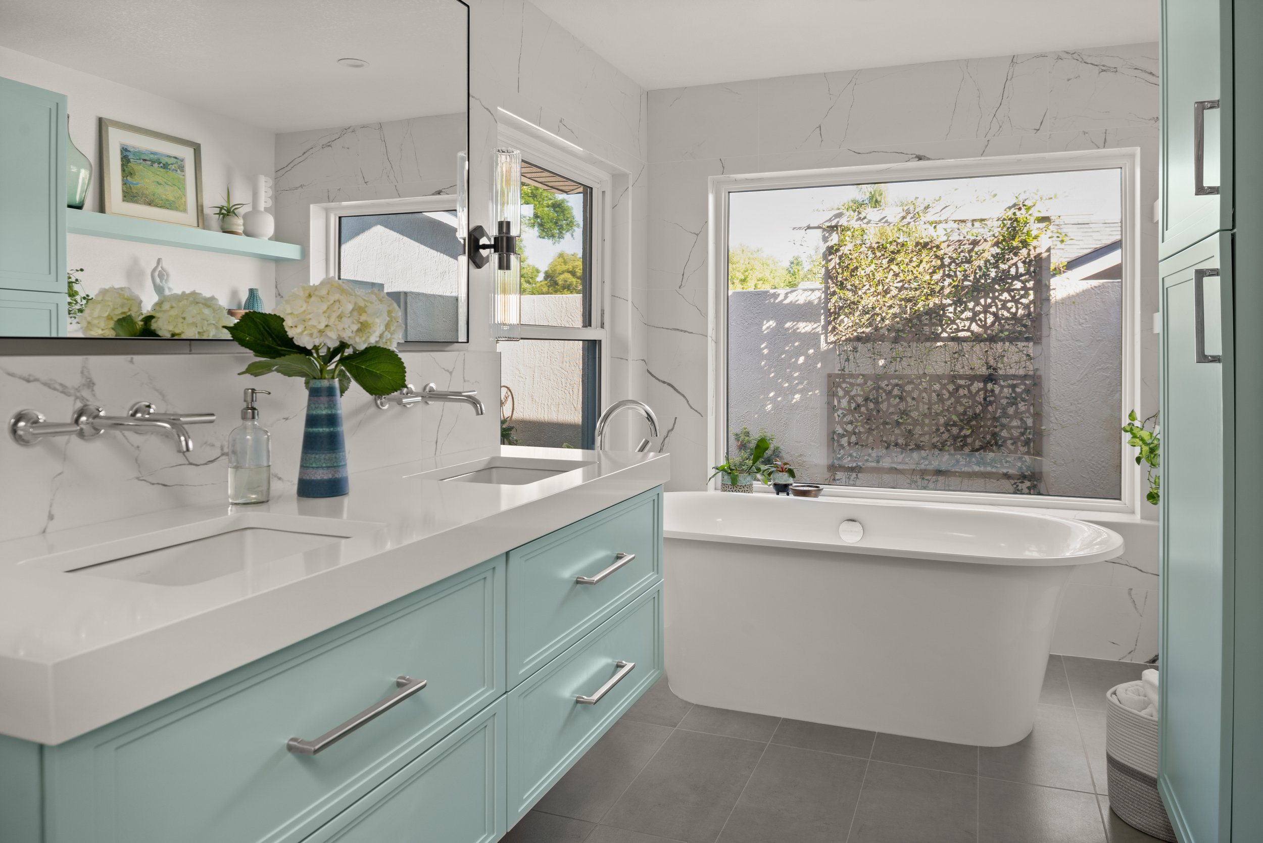 remodeled bathroom by Lindross Remodeling features a freestanding tub and custom vanity in Sherwin-Williams Tidewater (SW 6477)