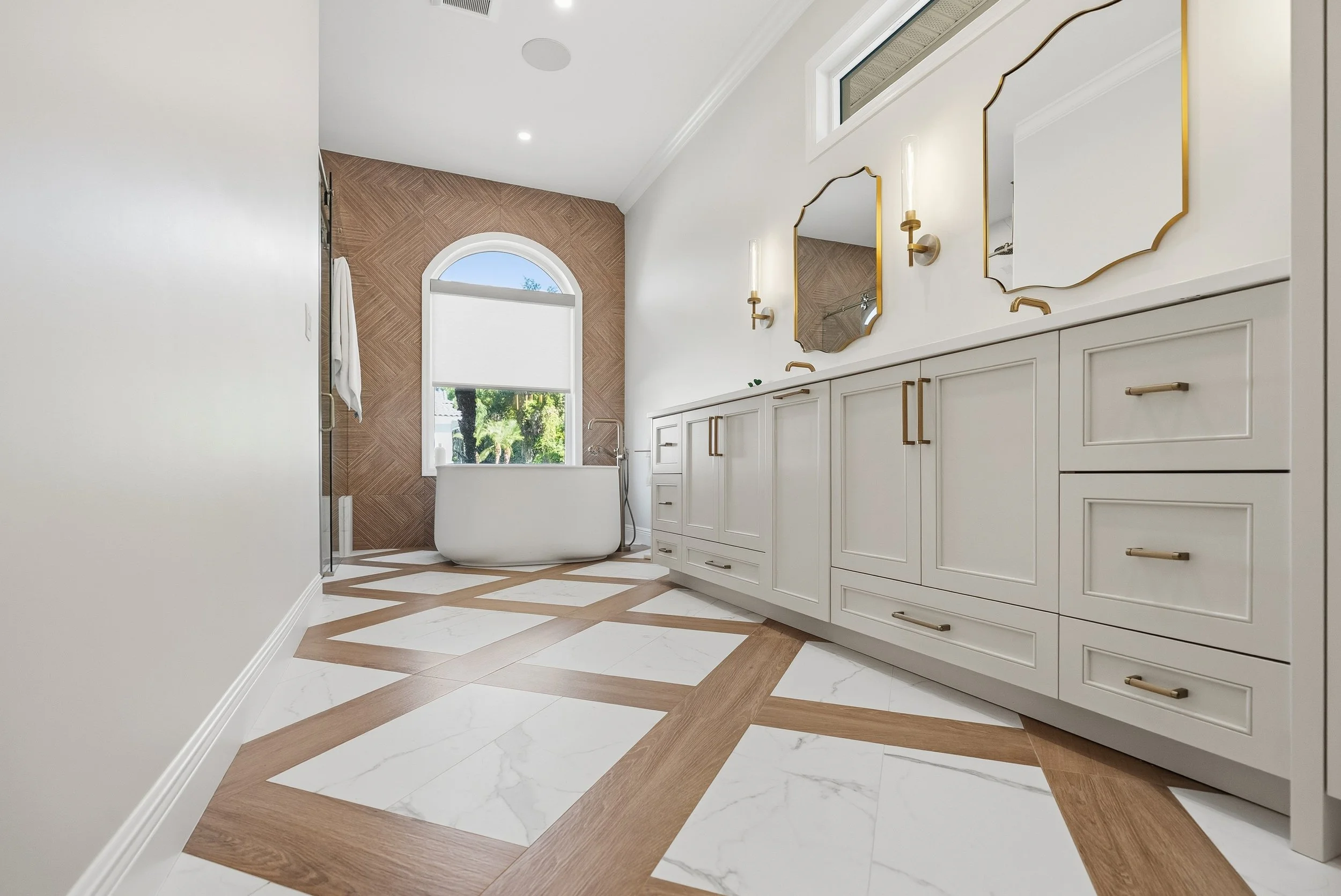 A Freestanding Tub Framed by an Arched Window | Lindross Remodeling