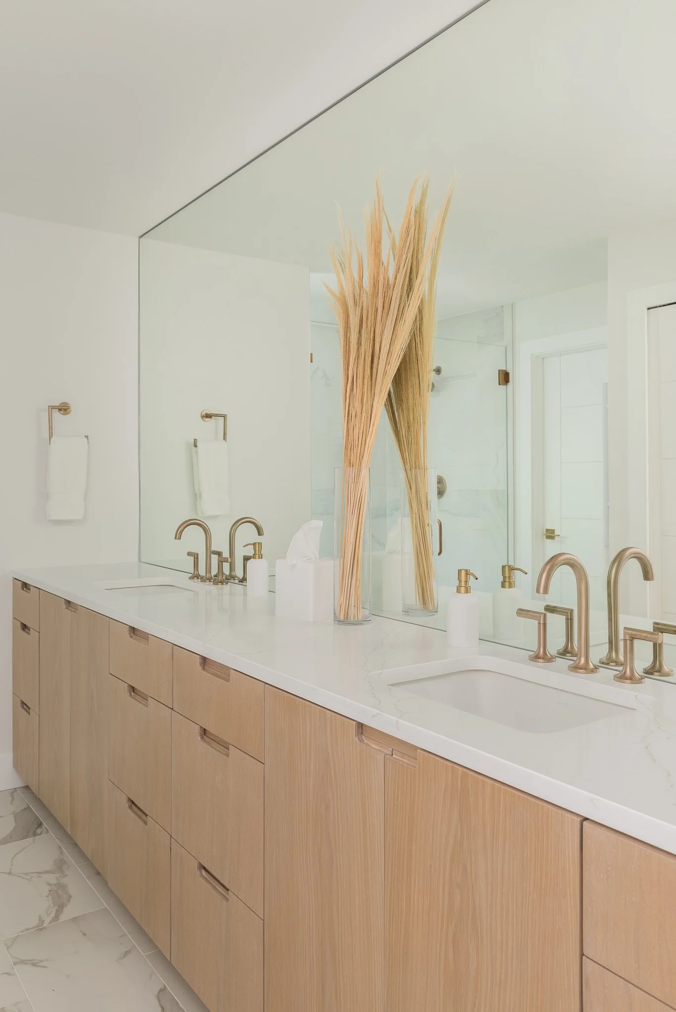 The two sinks on this double bathroom vanity with a full wall mirror in a custom bathroom in Tarpon Springs
