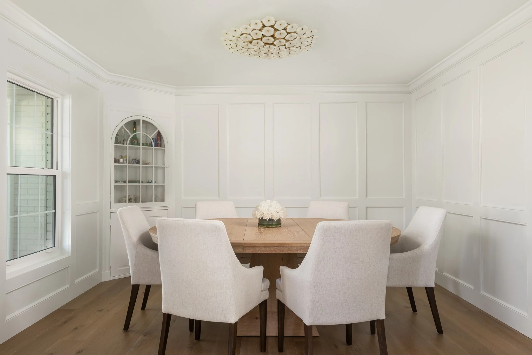 this beautiful paneled dining room with a statement light fixture was a part of this full home renovation in south Tampa