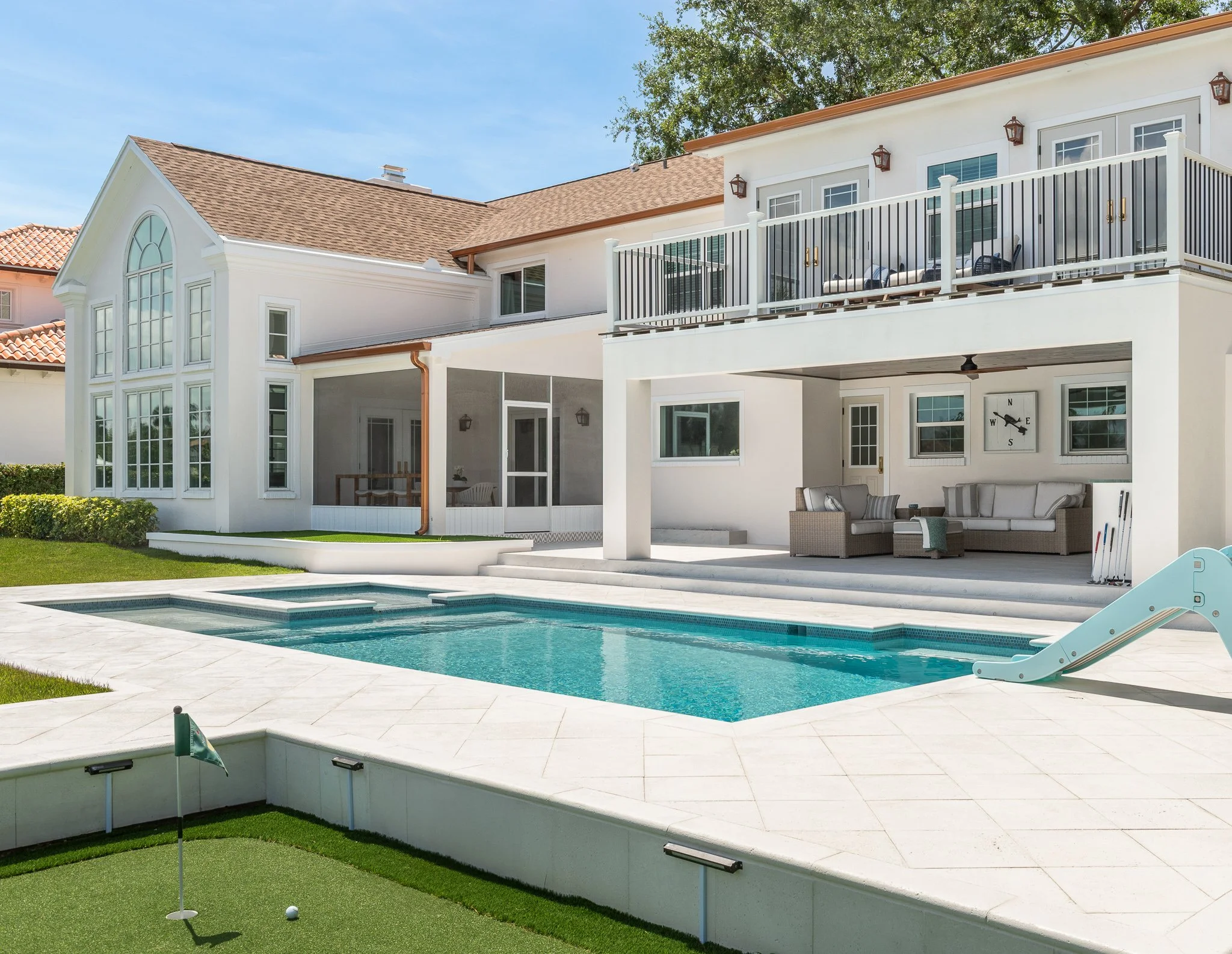 manicured outdoor space with a covered porch, pool, screen covered dining room: part of the whole home renovation in South Tampa