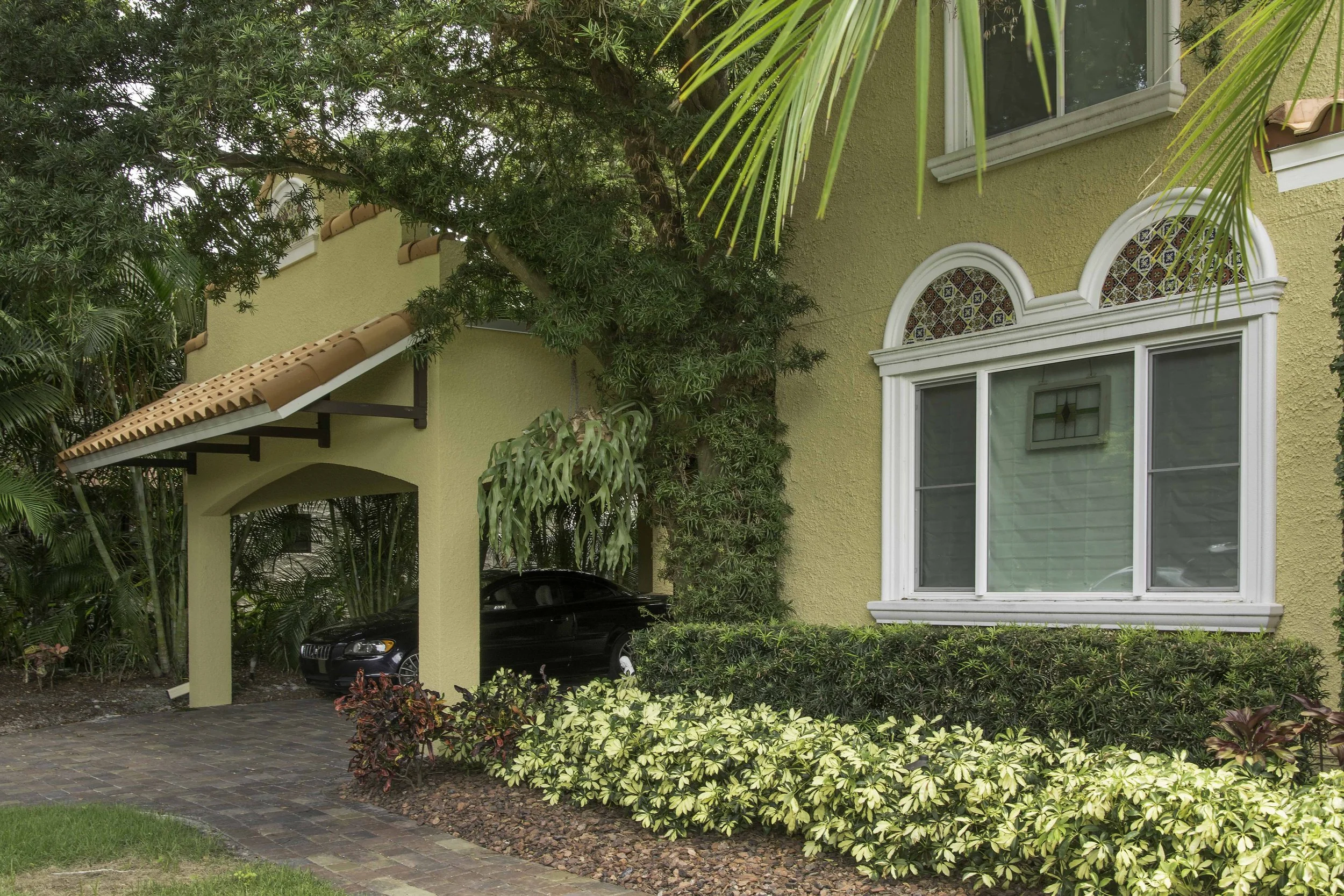 red tile roof, The stucco exterior on Spanish style carport in south tampa