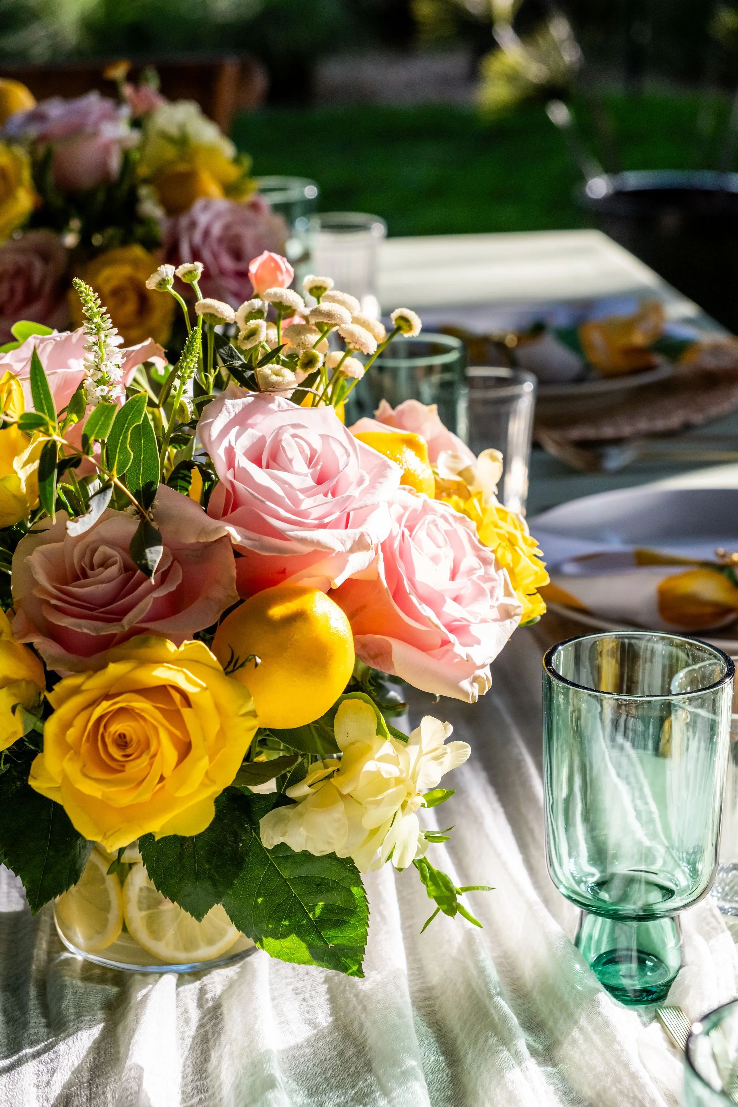 gorgeous centerpiece with lemons and roses at a private party setup in south florida at a custom Backyard Covered Patio
