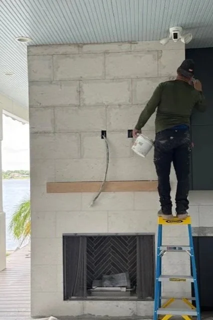 Lindross Remodeling Project Manager is grouting stone on the fireplace during a whole home remodel in ST. Patersburg