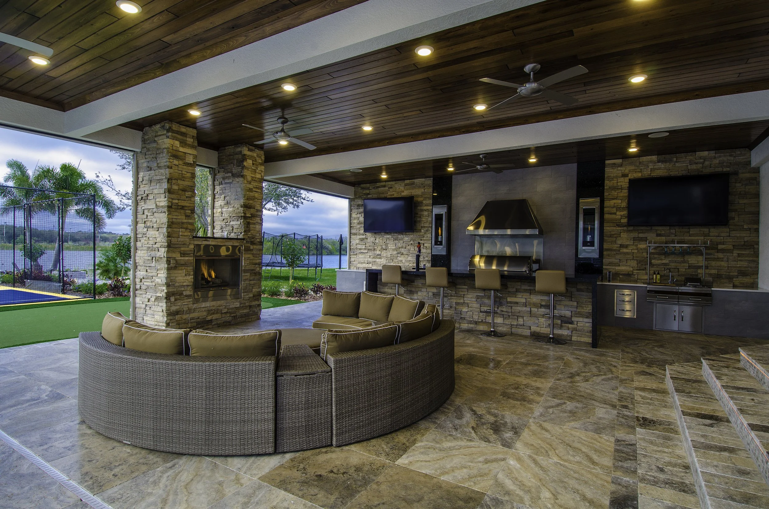 spacious party patio addition with outdoor bar, fireplace, kitchen, and lots of seating