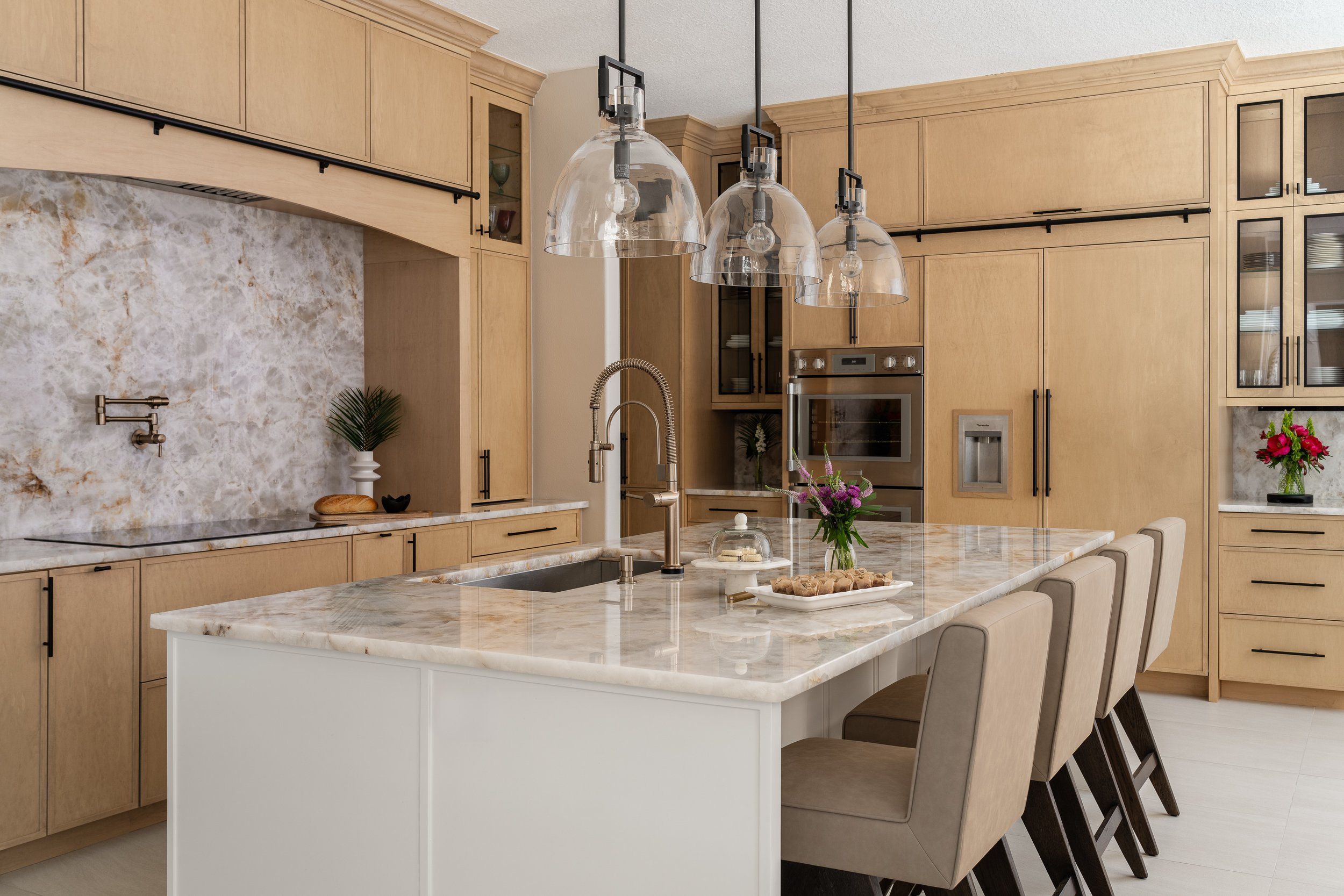 a beautiful custom l-shaped kitchen by Lindross Remodeling with a Sink in the Island