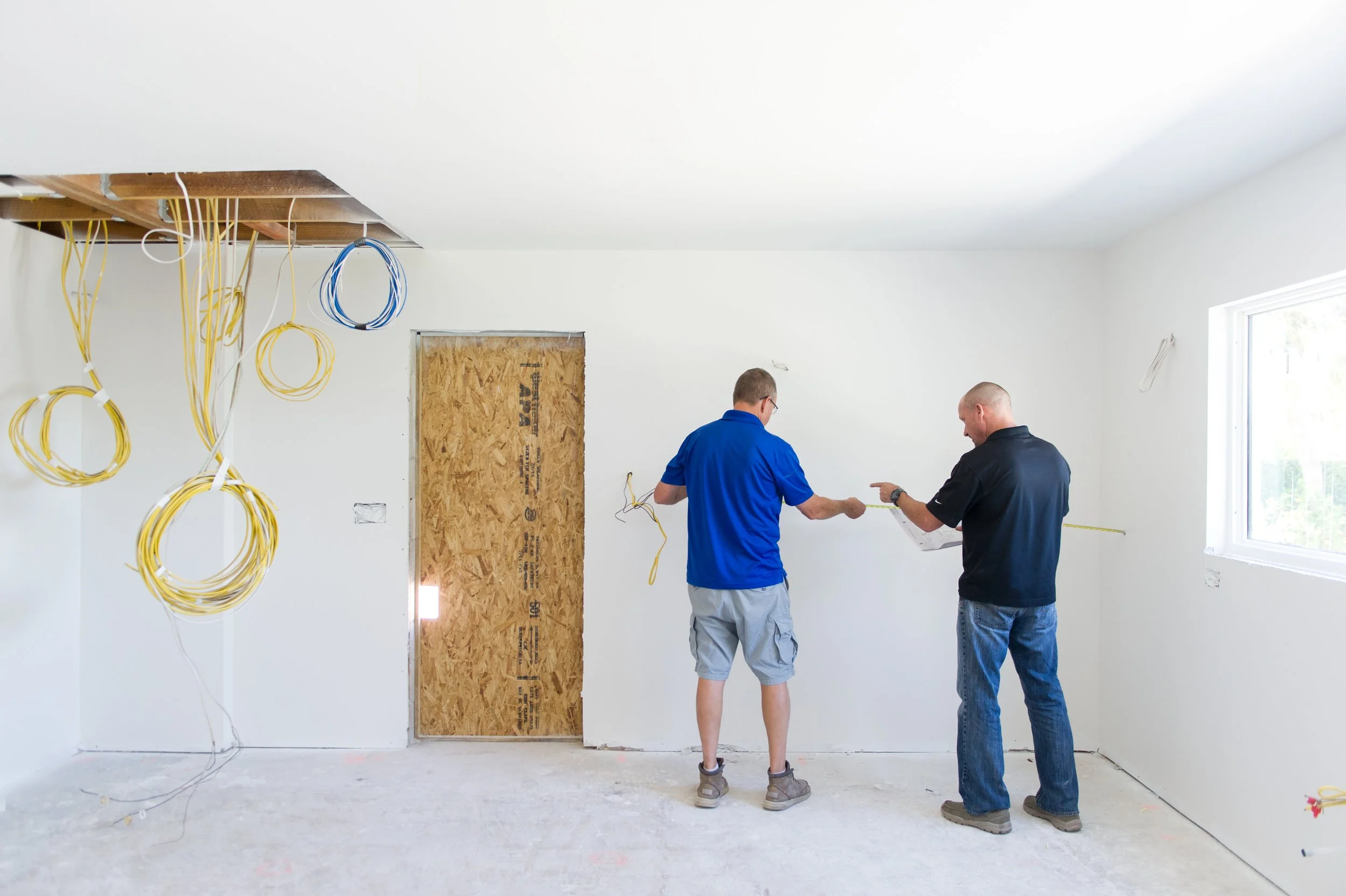 Lindross Remodeling team is on a job site doing measurements during a whole home remodel in Tampa