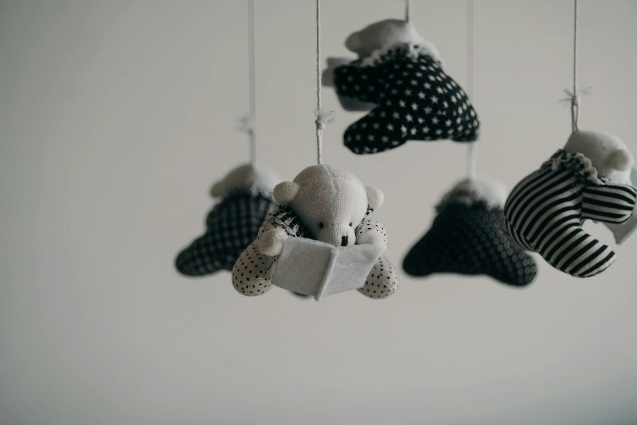picture of bears reading books from mobile strings in a nursery