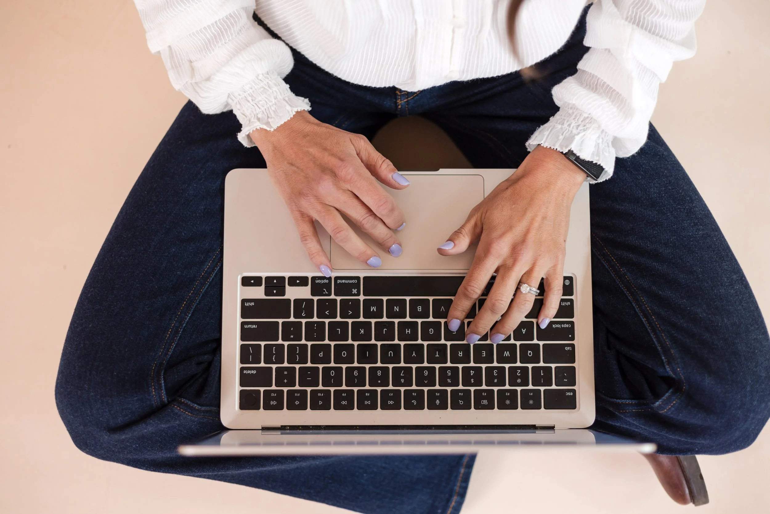 Brittany Sallaberry typing on laptop to provide online therapy in CA