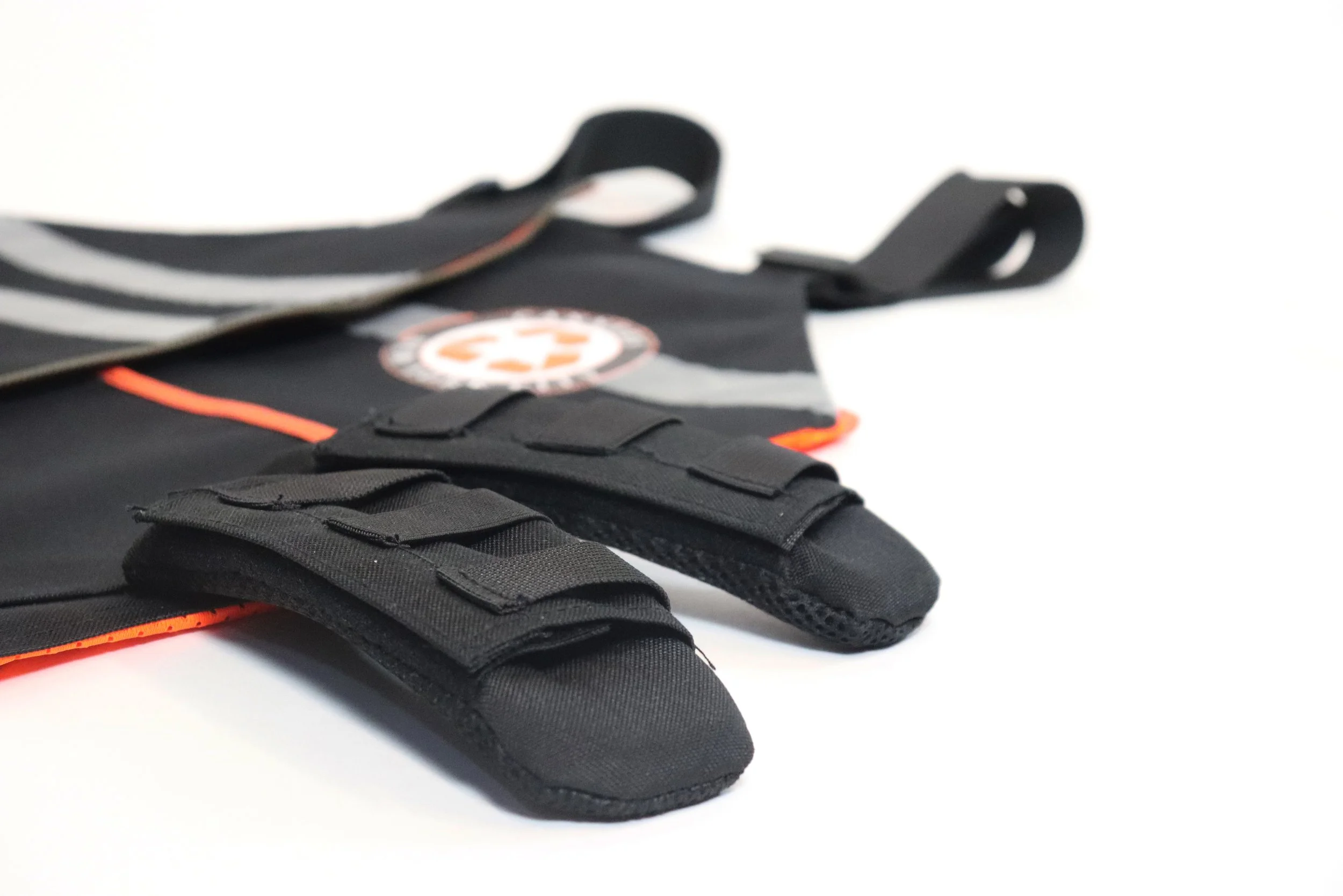 Close-up of a black emergency or medical backpack with padded gloves on a white background.