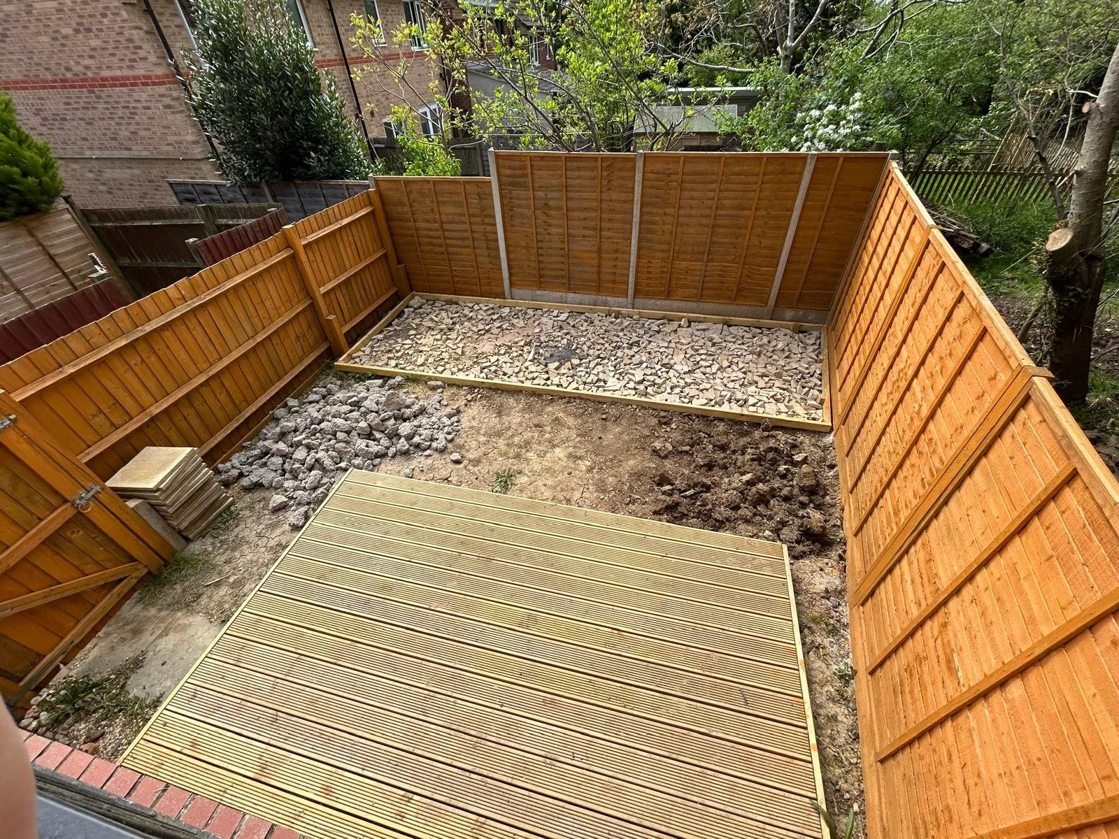 Once the decking was complete, attention turned to the rest of the garden. We laid and compacted hardcore, creating the perfect foundation for the artificial turf that would follow. Every layer matters in ensuring a finish that not only looks good bu