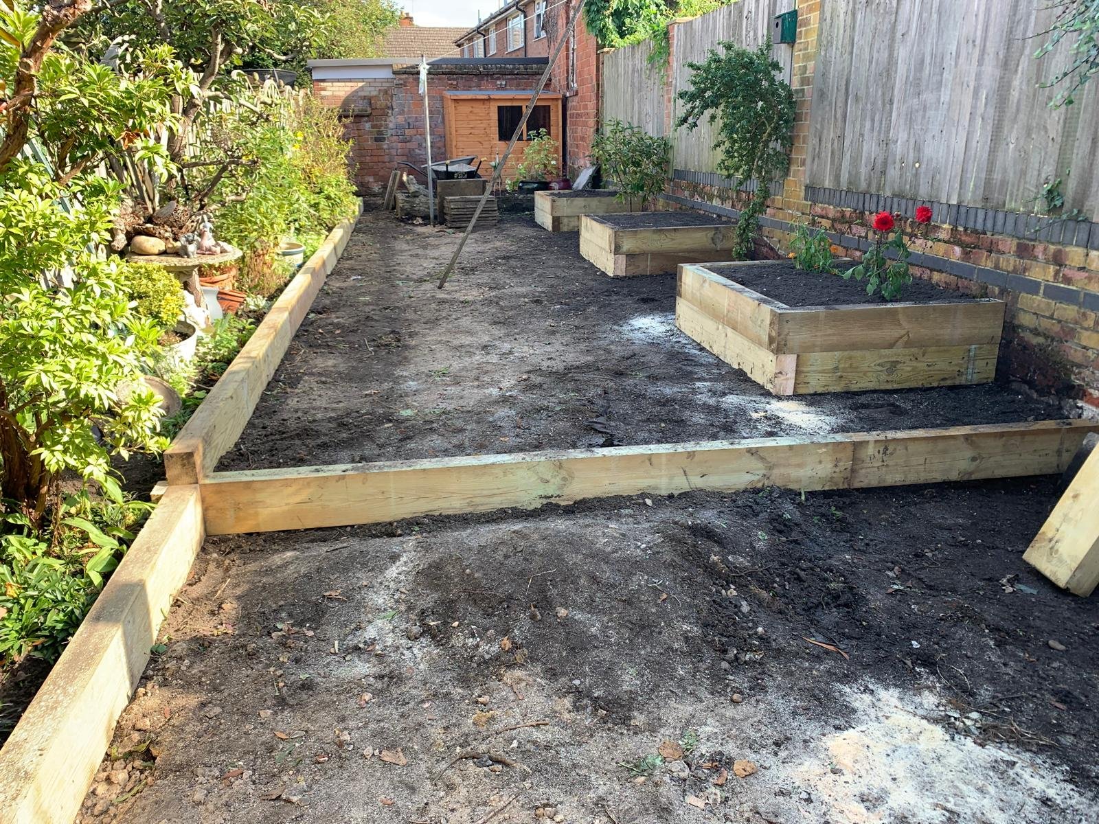 After clearing the space, we leveled the garden using topsoil to create a stable foundation for the new features. We also installed timber borders to define the space, creating a split-level design that added depth and structure to the layout. The ad