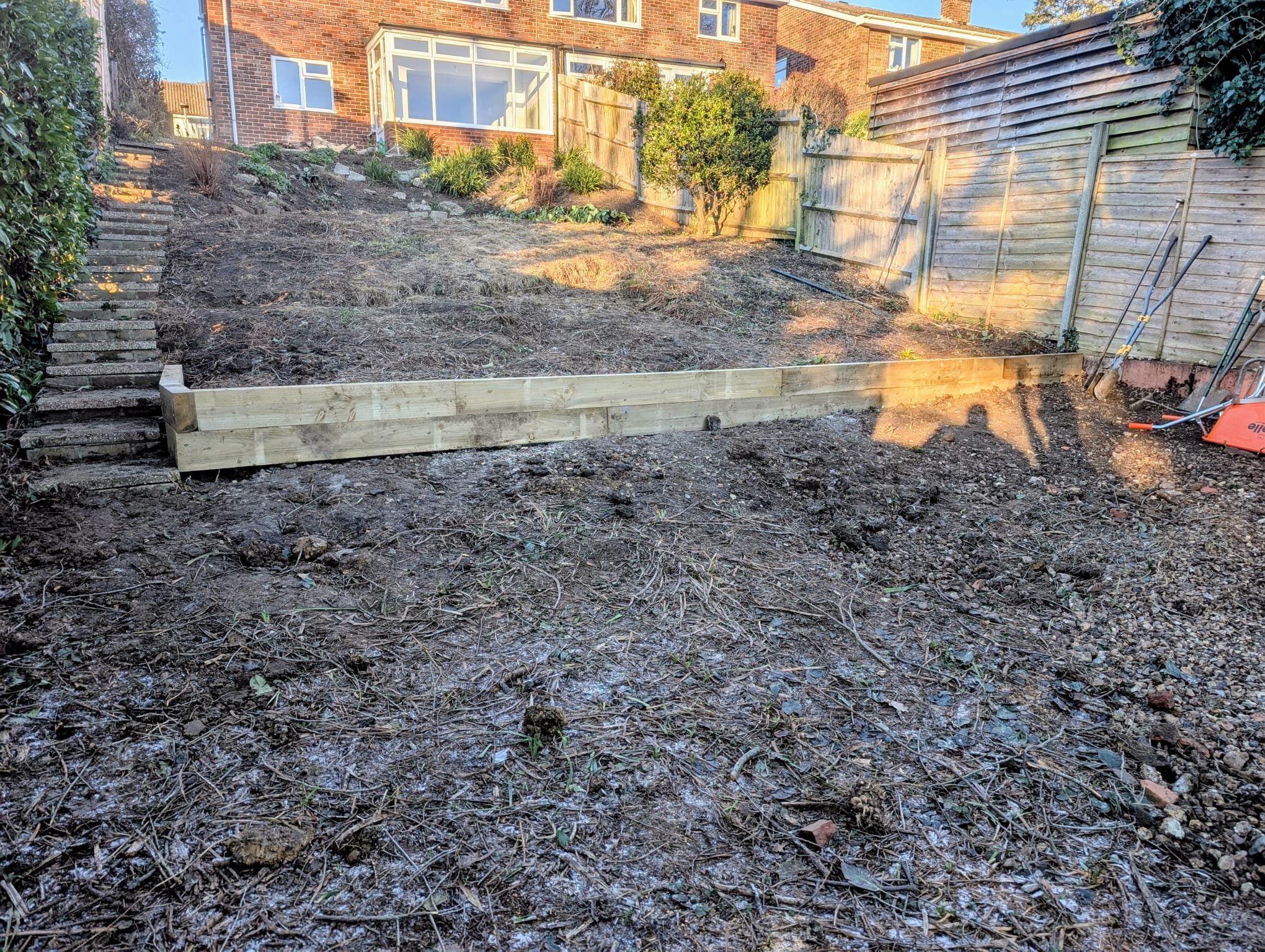 The failing brick retaining wall was removed and replaced with new, pressure-treated timber sleepers. This not only provided a cleaner, more modern look, but also reinstated a clear split between levels, creating strength, stability, and long-term du