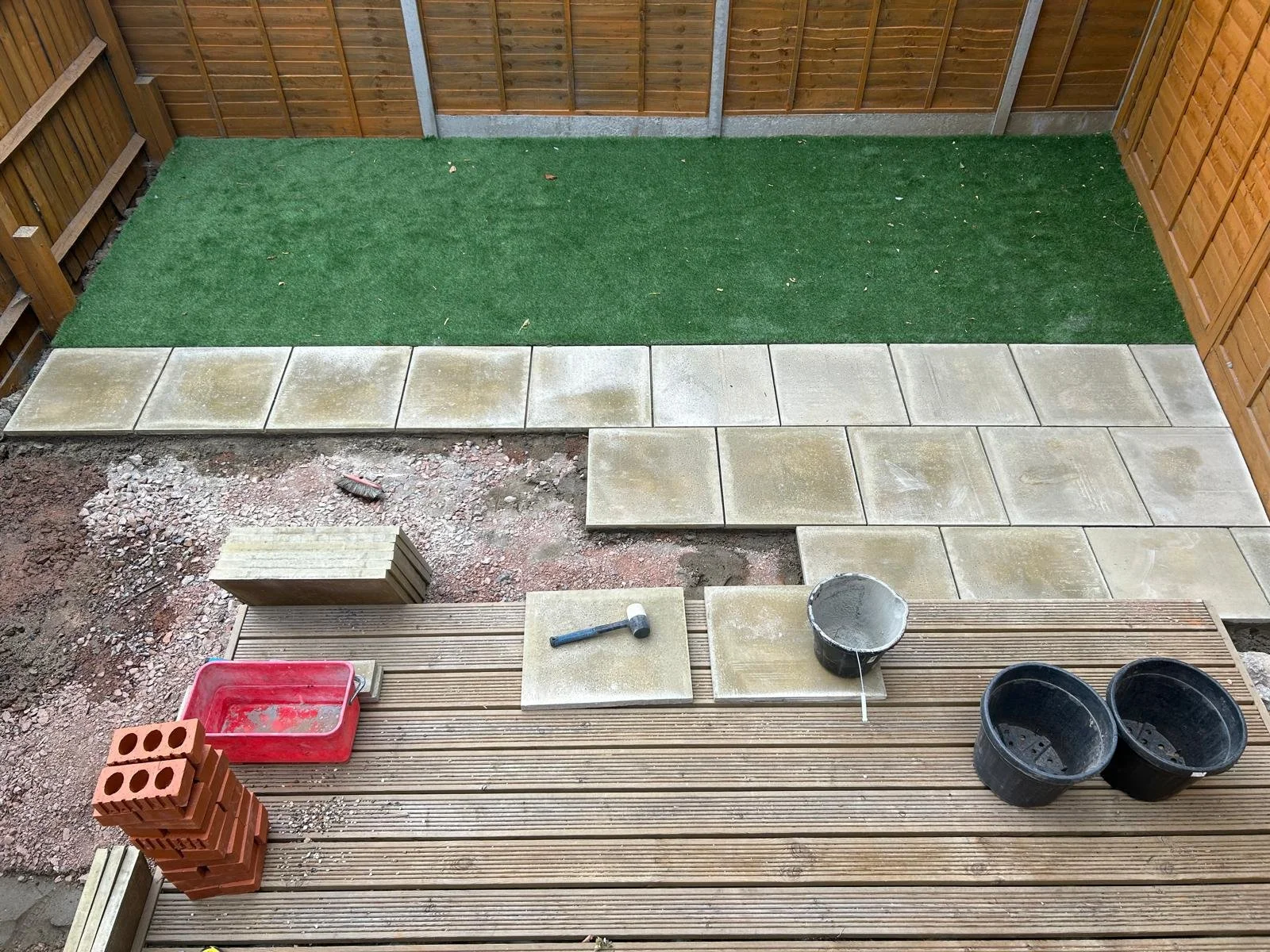 Midway through paving, the design vision was now clearly emerging. Clean lines and smart layout choices were replacing what had once been a cluttered, unusable space.