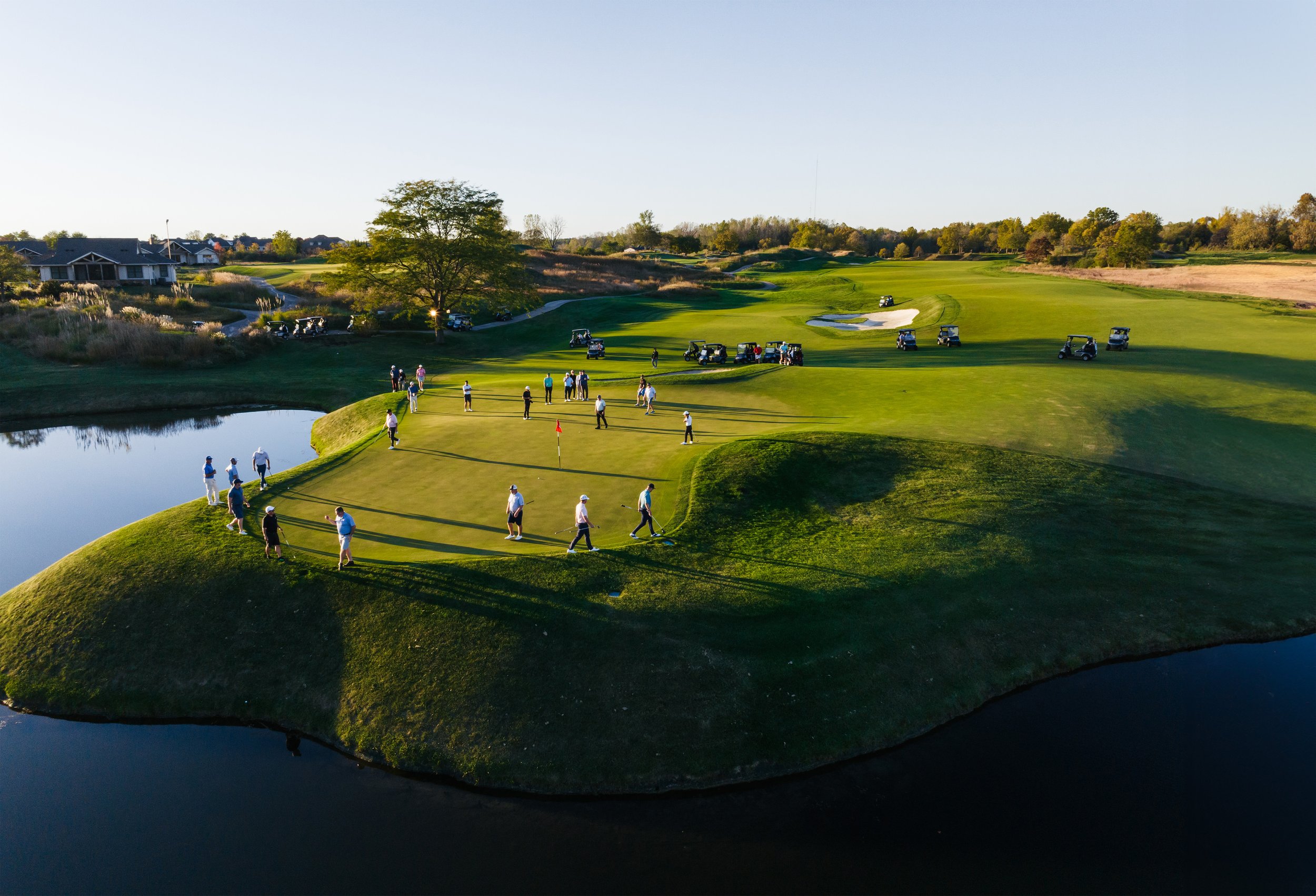 A group of people playing golf at Victoria National, a Dormie Network course
