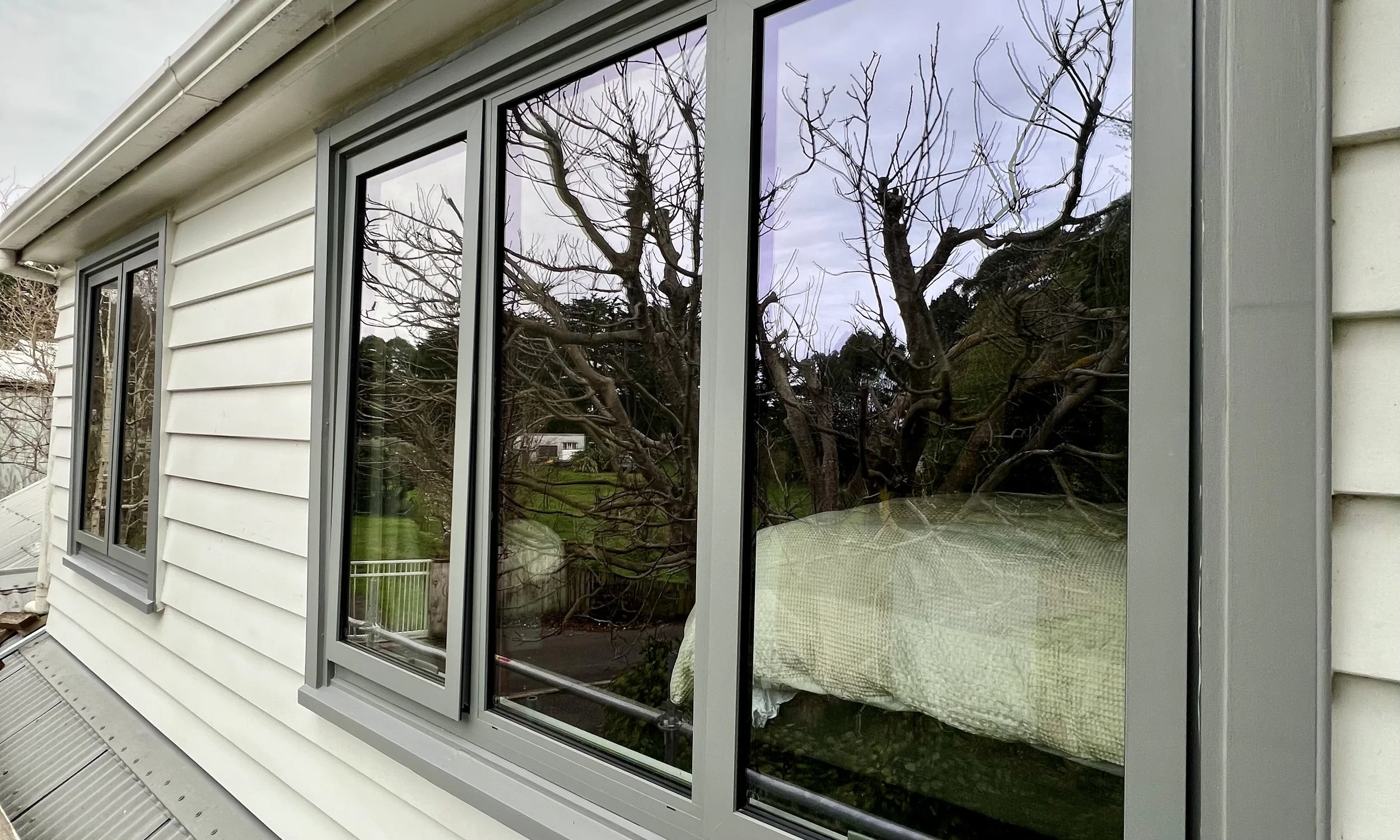 New double glazed and thermally broken aluminium joinery retro-fit into a timber weatherboard house on the Kapiti Coast.