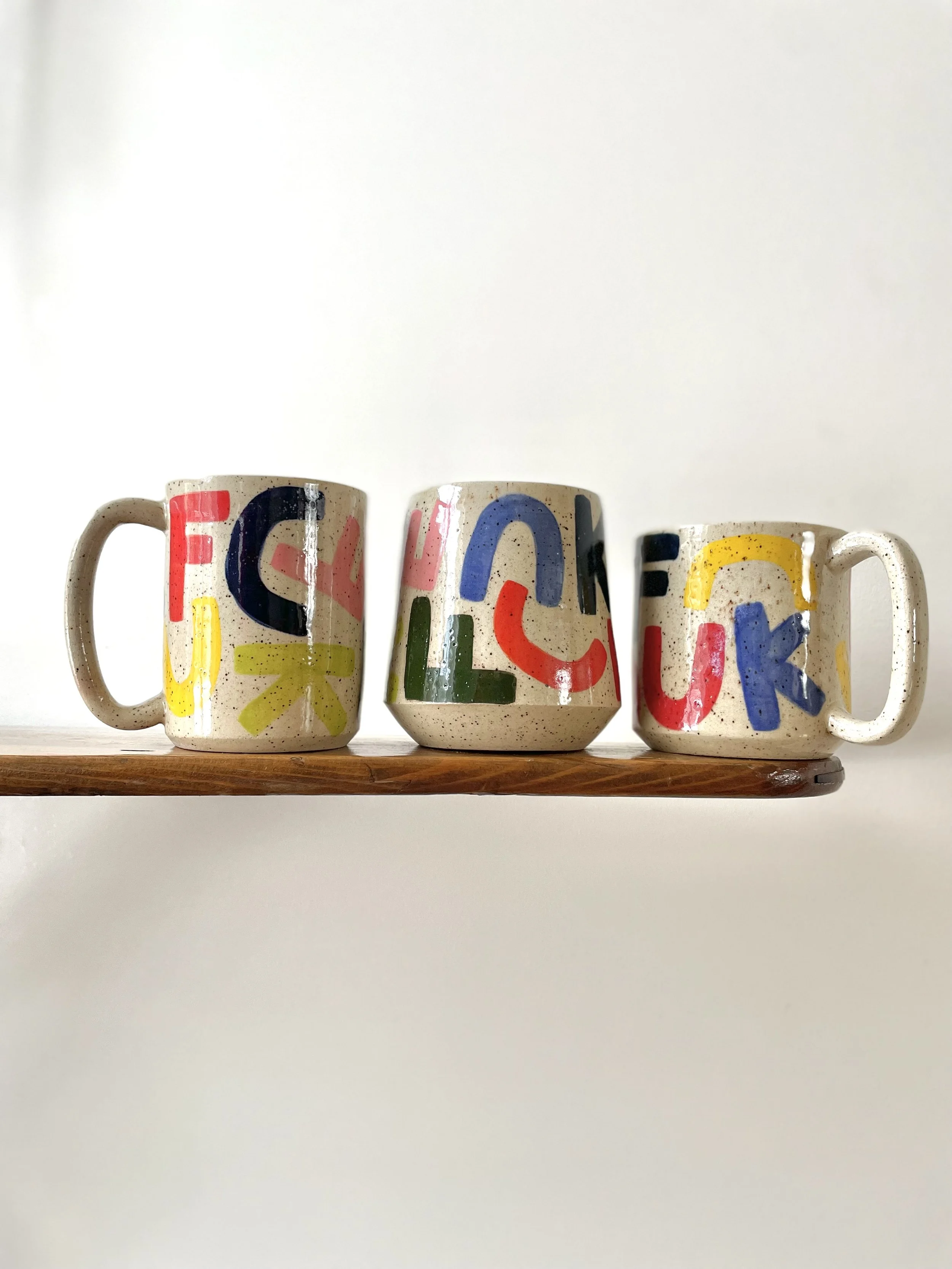 F-C-U-K Mug with solid rainbow letters, speckled gloss