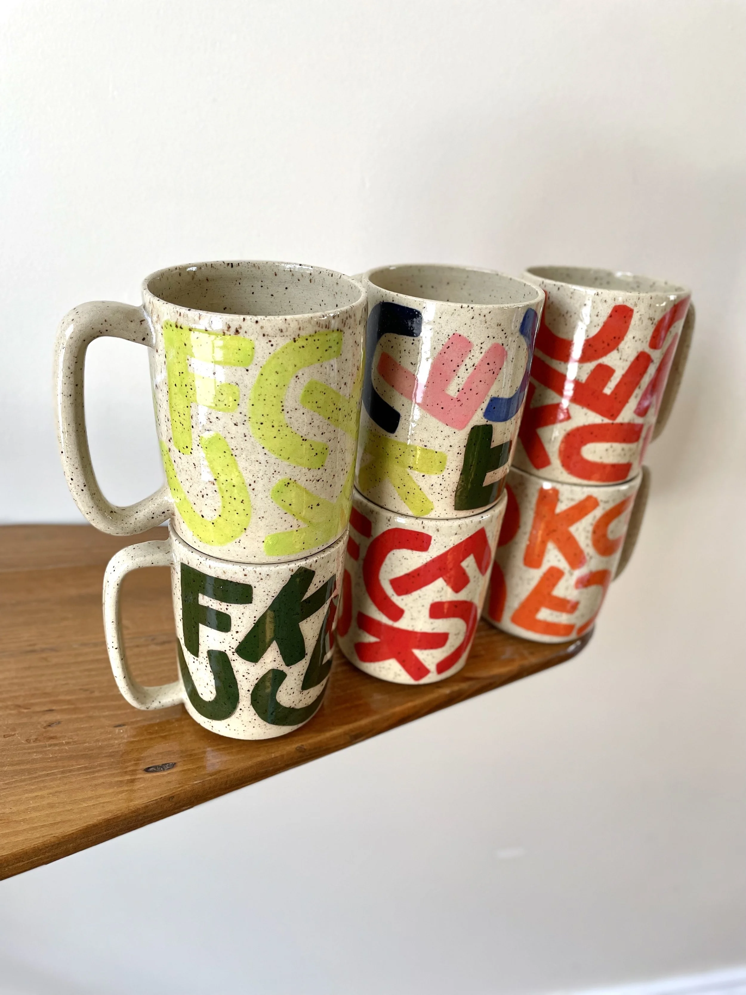 F-C-U-K Mug with solid colour letters, speckled gloss