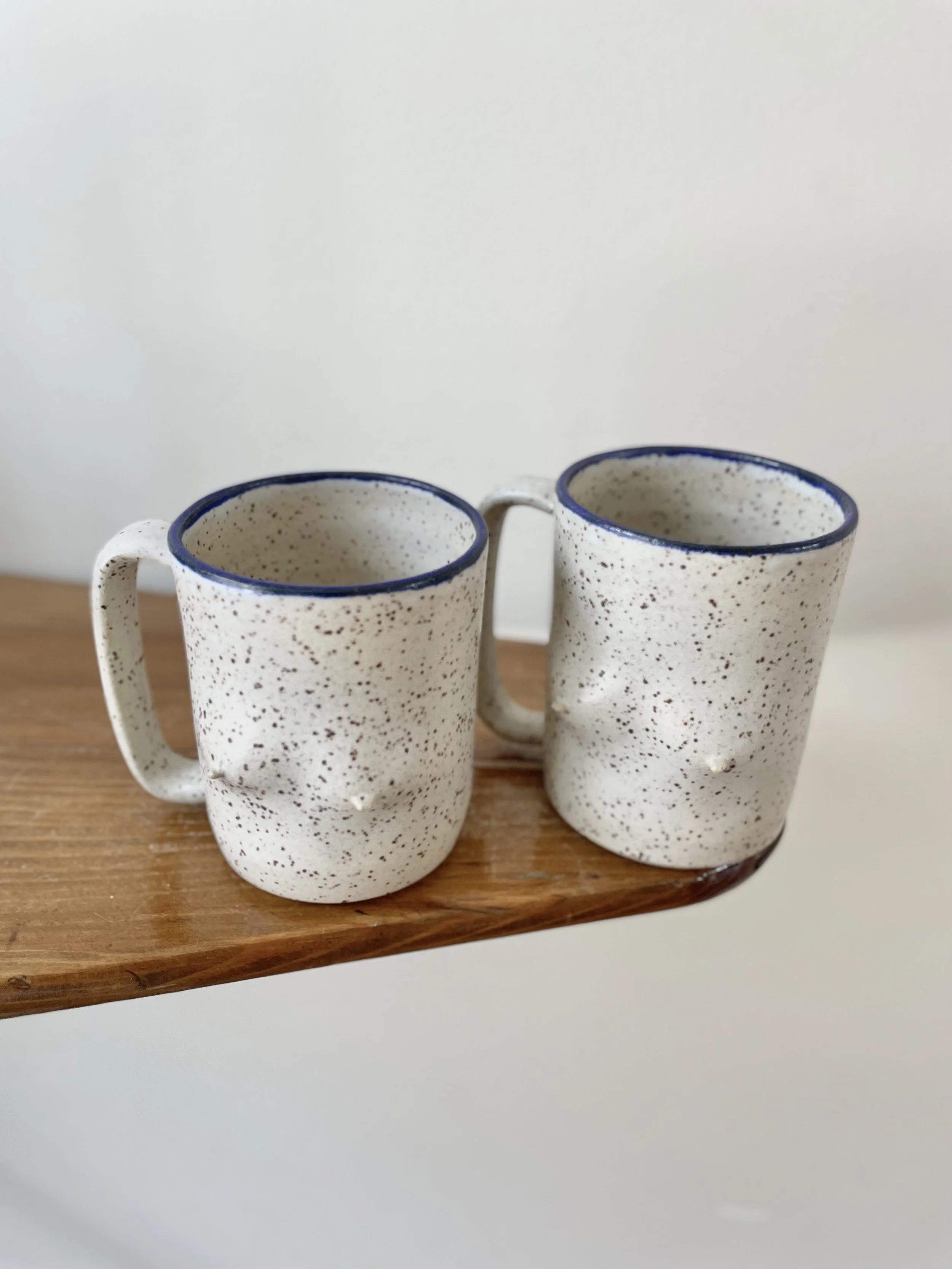 Speckle matte white Breast mug with cobalt blue rim