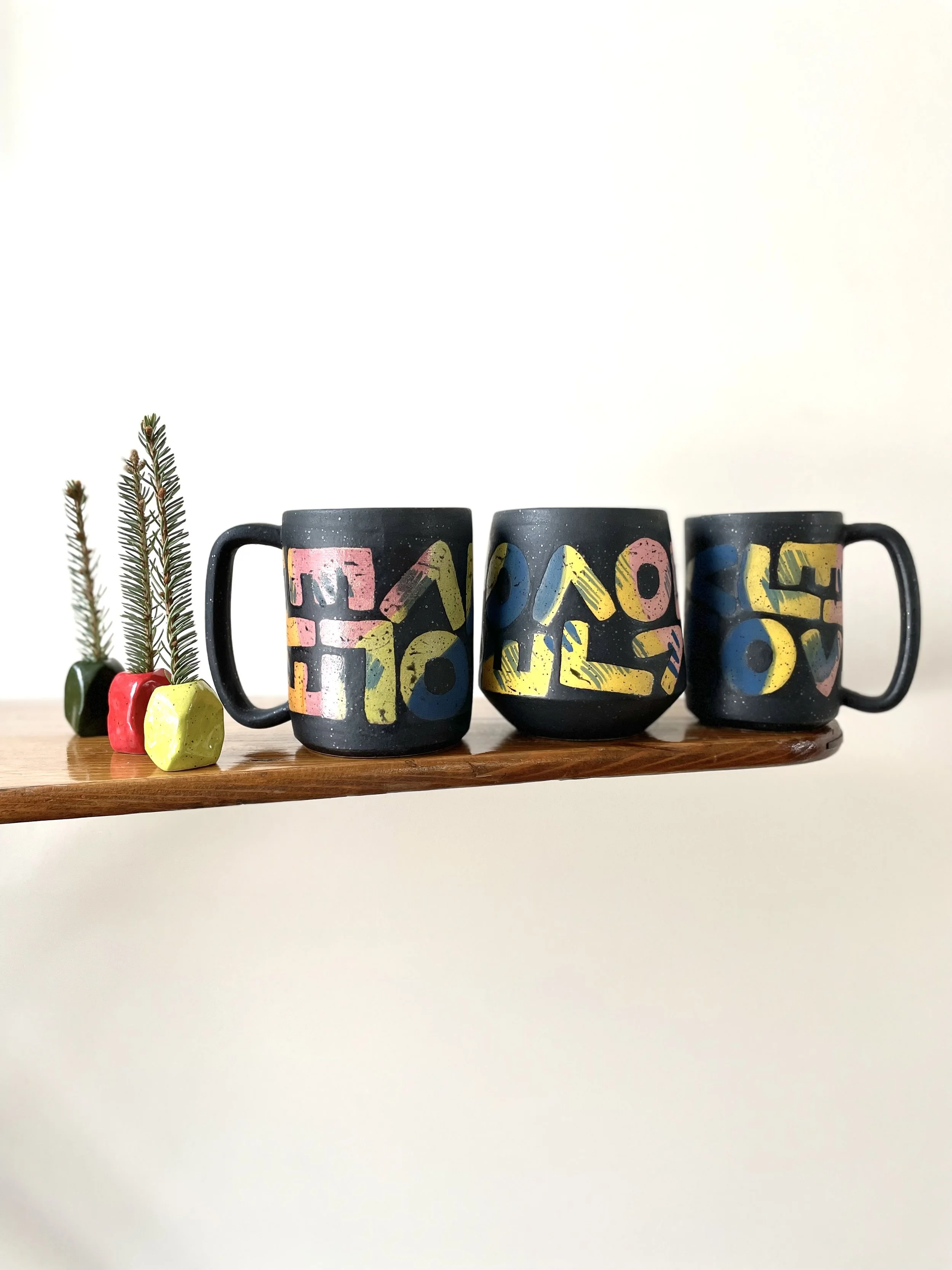 L-O-V-E Mug with colour splatter letters, speckled matte black