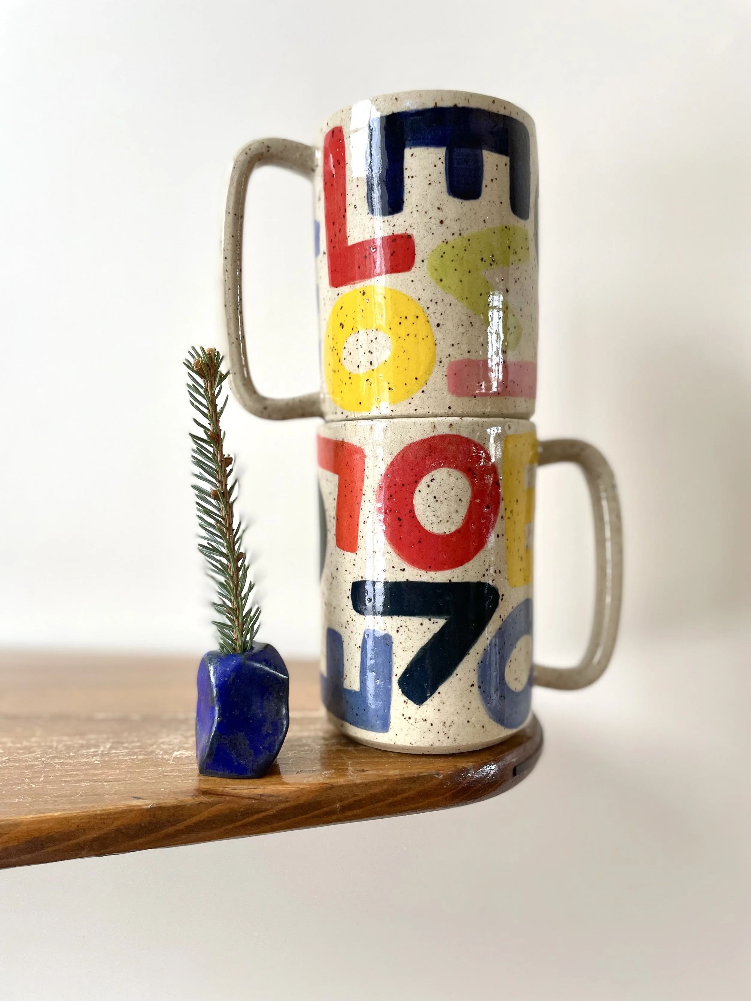 L-O-V-E Mug with solid rainbow letters, speckled gloss