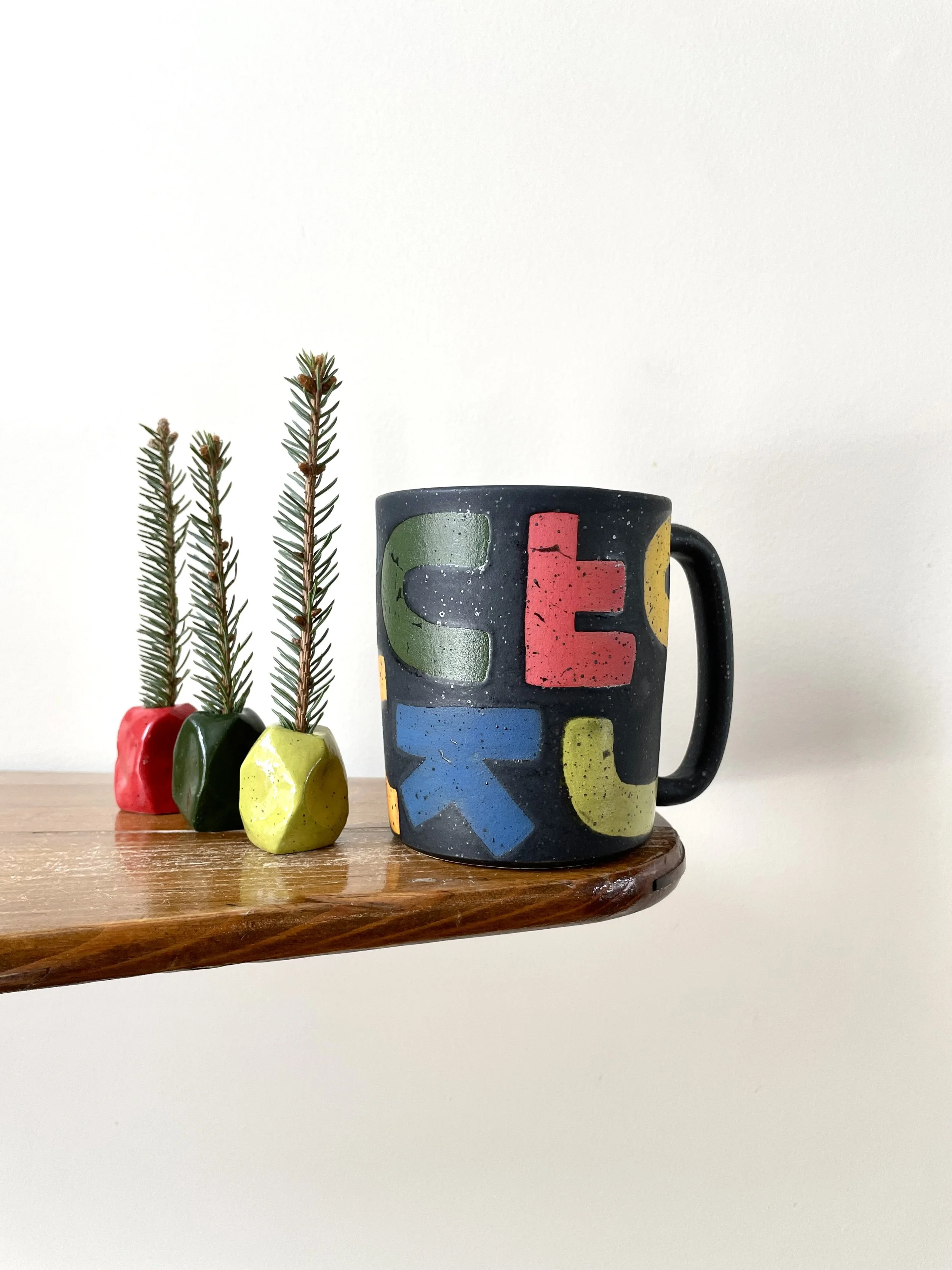 F-C-U-K Mug with solid rainbow letters, speckled mate black