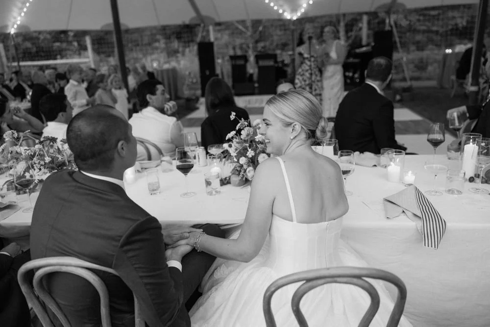 Wedding florals at The Henson, Hensonville, NY — gardeny red, creams, and greens with seasonal produce by Fiora floral design, Hudson Valley wedding florist.