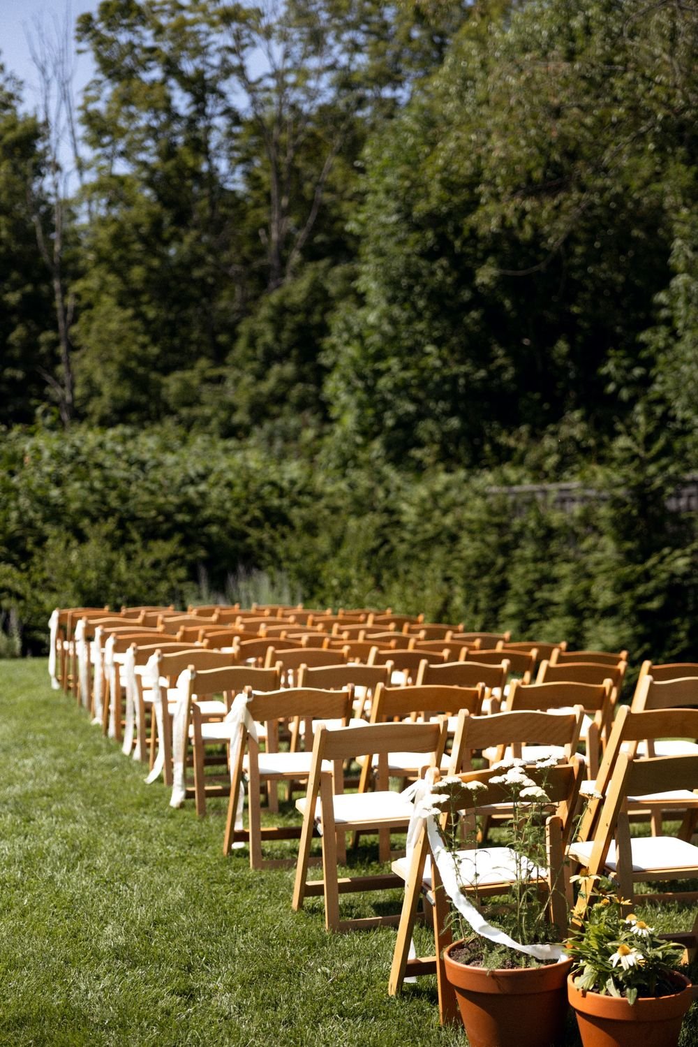 Wedding florals at The Henson, Hensonville, NY — gardeny red, creams, and greens with seasonal produce by Fiora floral design, Hudson Valley wedding florist.