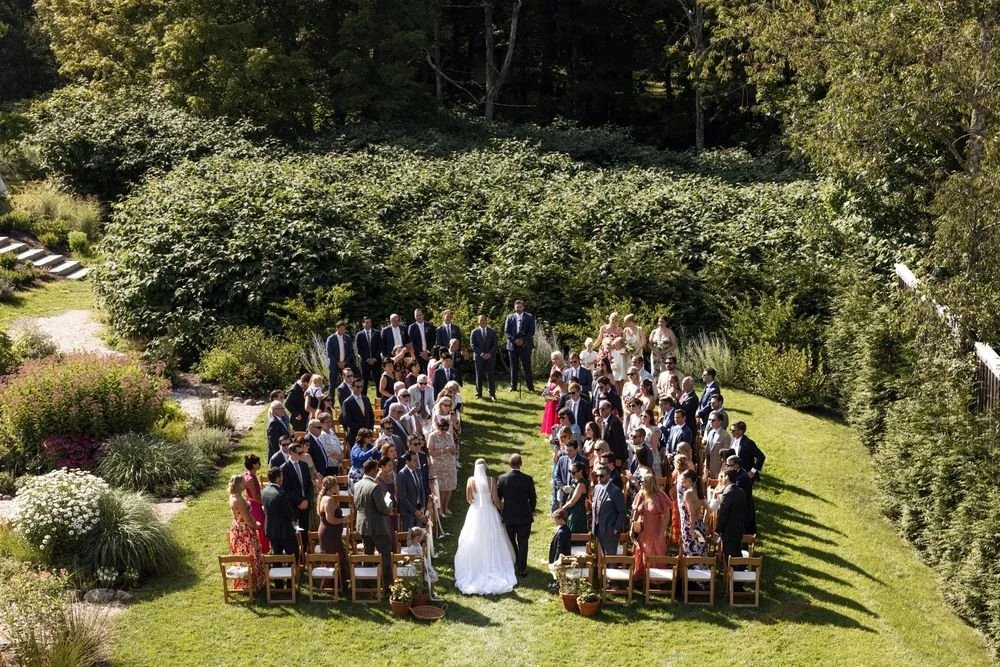 Wedding florals at The Henson, Hensonville, NY — gardeny red, creams, and greens with seasonal produce by Fiora floral design, Hudson Valley wedding florist.