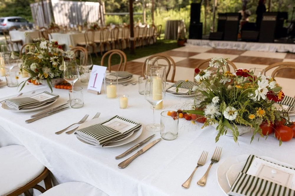 Wedding florals at The Henson, Hensonville, NY — gardeny red, creams, and greens with seasonal produce by Fiora floral design, Hudson Valley wedding florist.