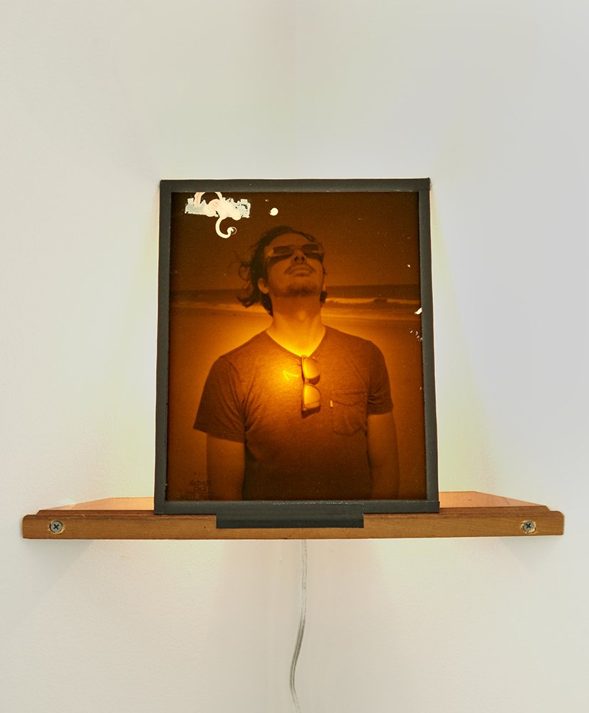 Eclipse, 2018 (Inkjet transparency mounted on 8x10 darkroom safe light filter, with lightbulb and custom corner shelf)