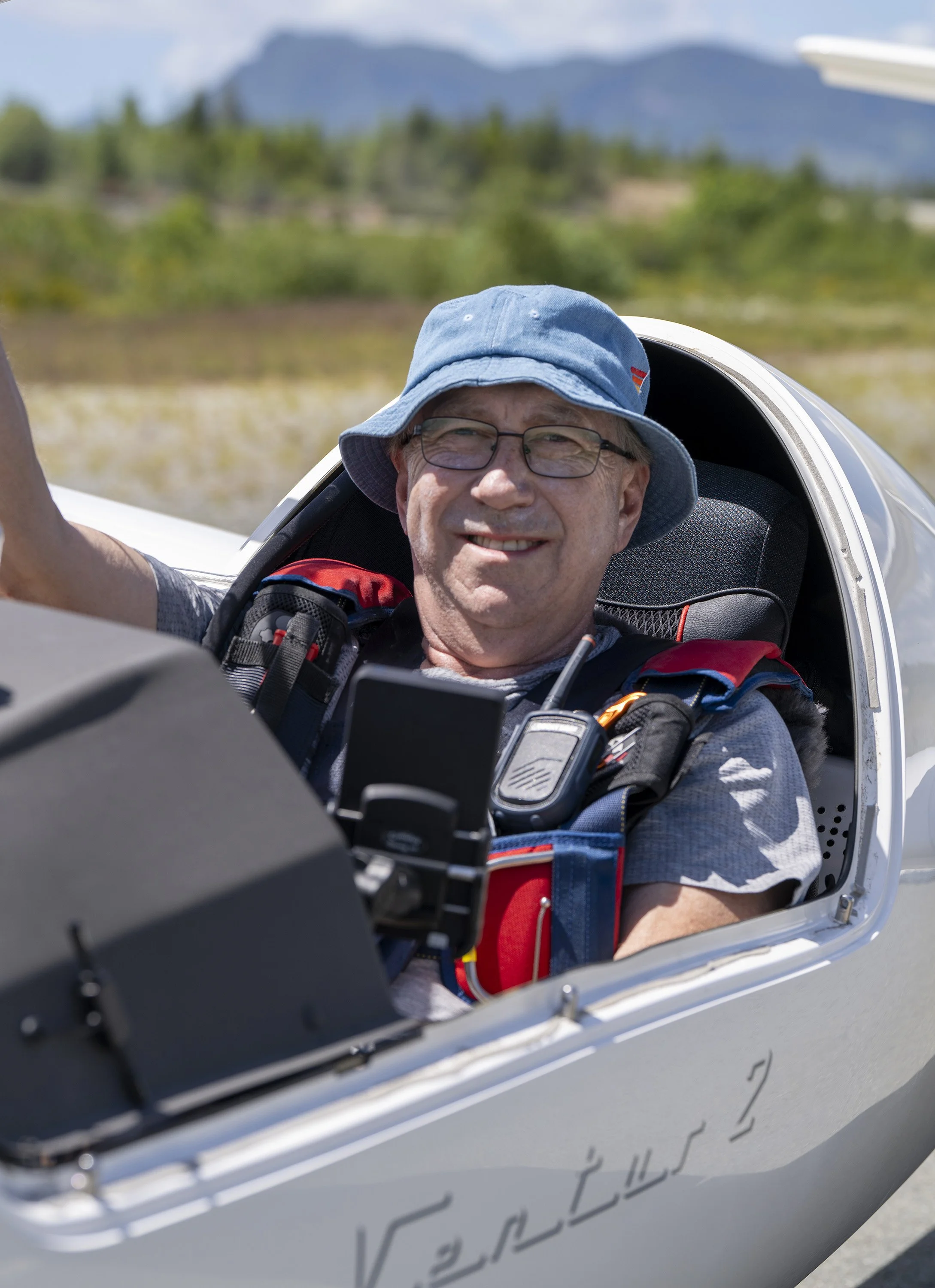A glider pilot smiles as he gets ready to launch into the air