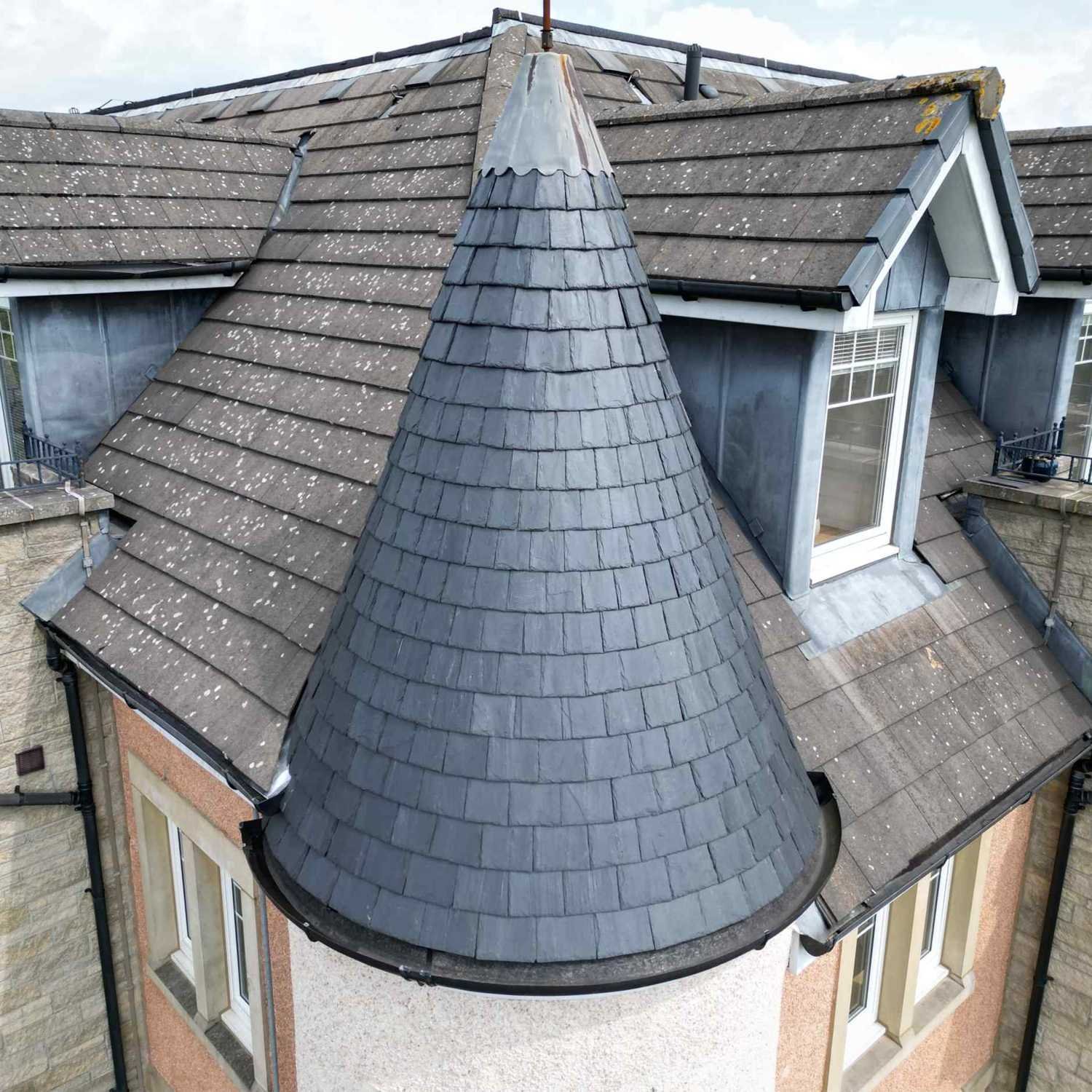 drone inspecting a slate covered turret roof