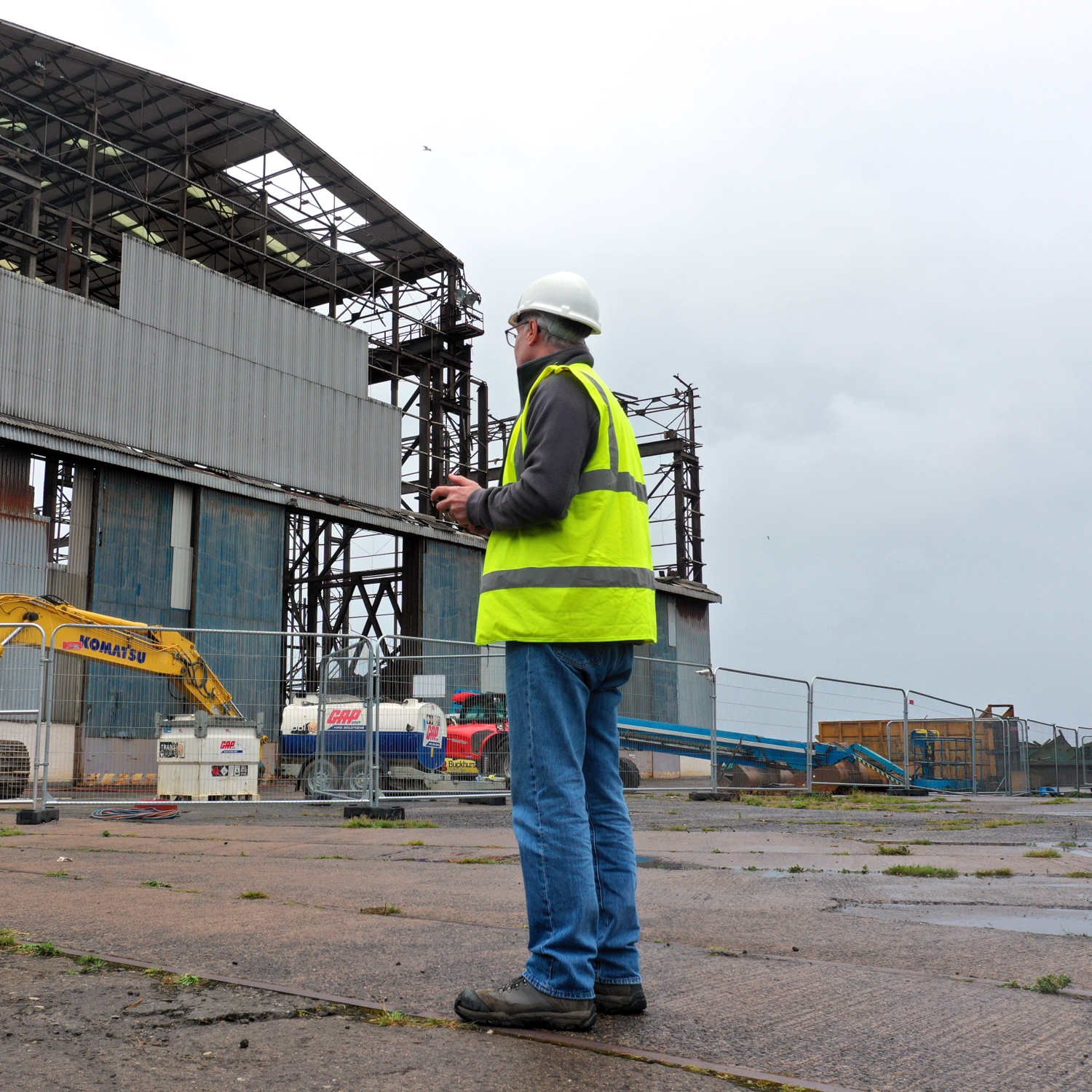 surveyor inspecting an industrial site with a drone