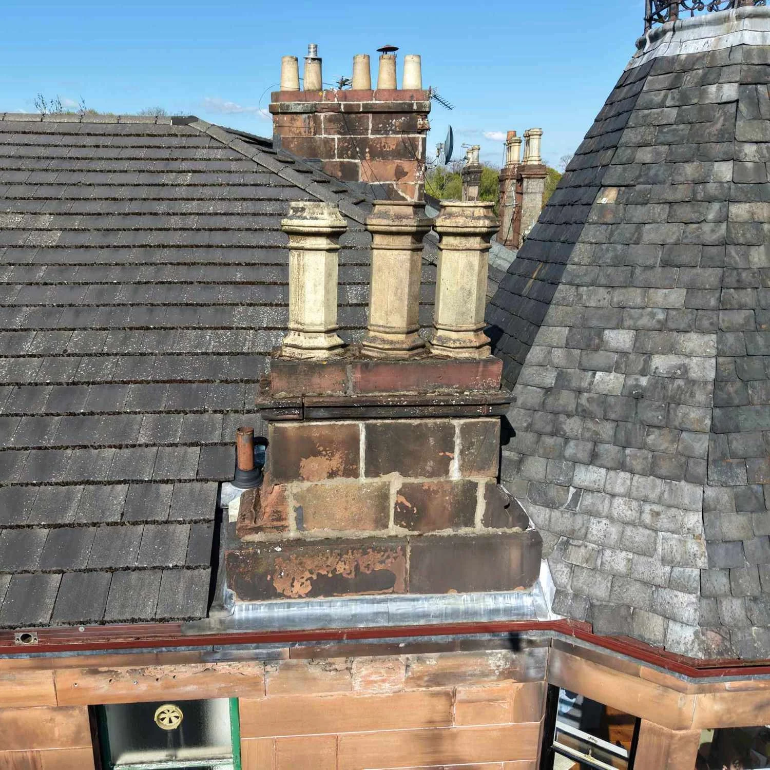 drone inspecting a chimney on a tenement building