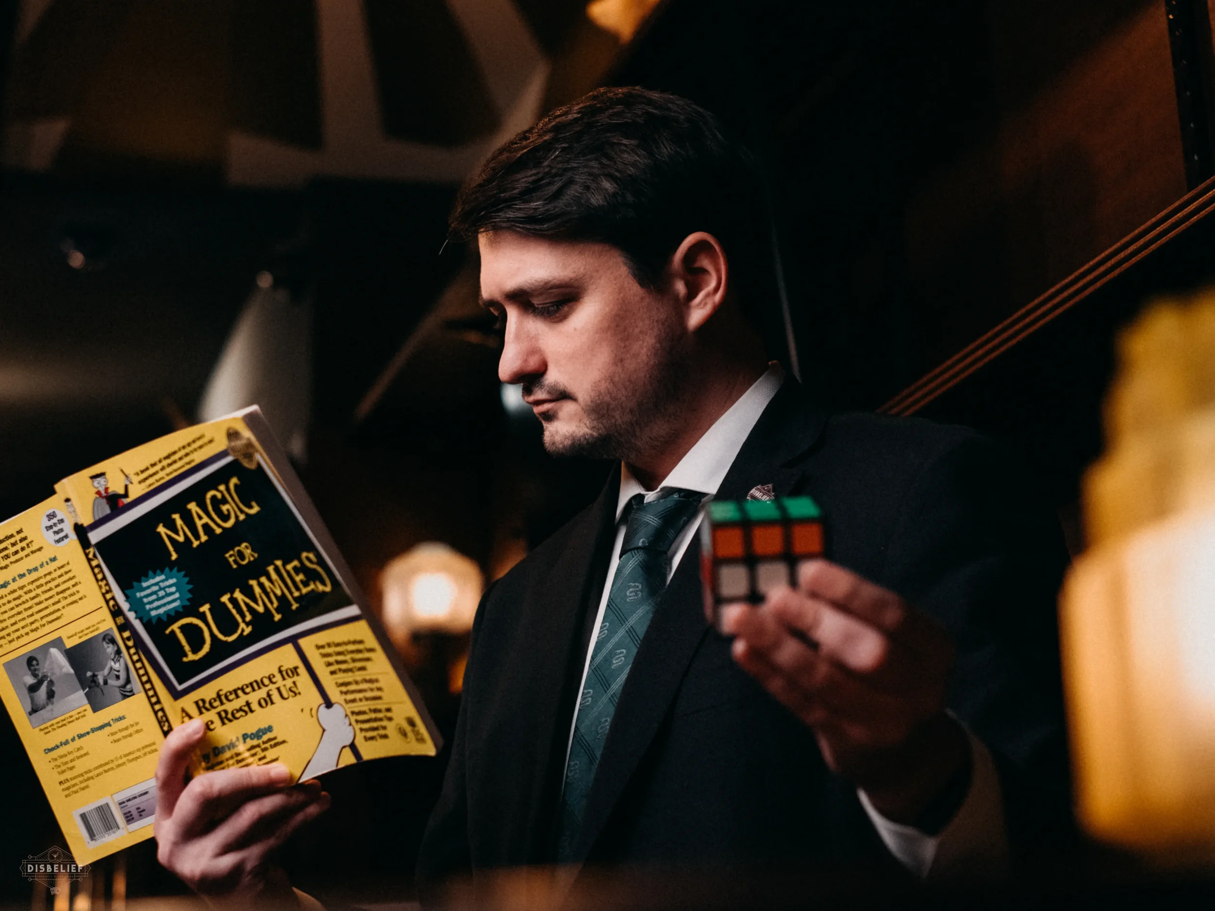 Corporate event magician Josh Weidner performing close-up magic for business guests