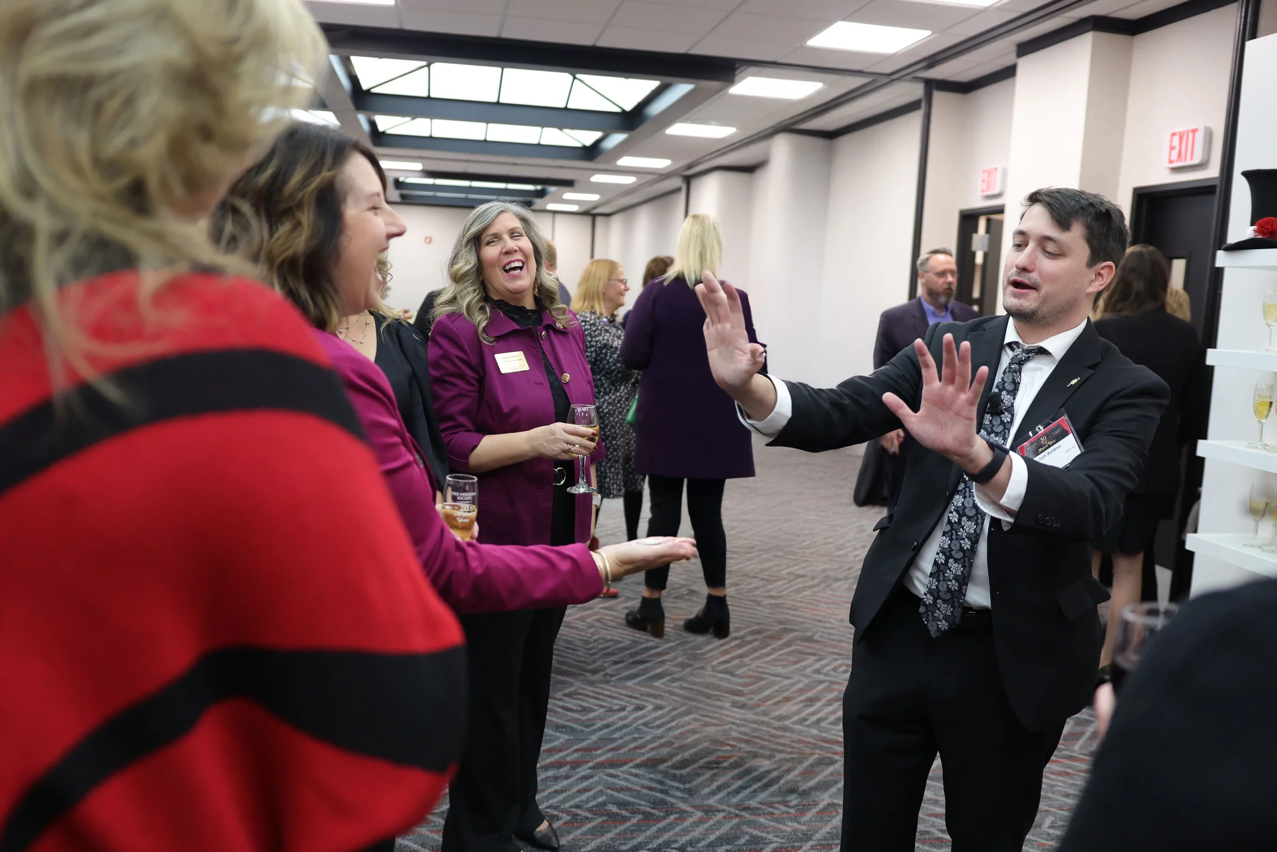 Speaker magician Josh Weidner on stage with a microphone at a corporate keynote