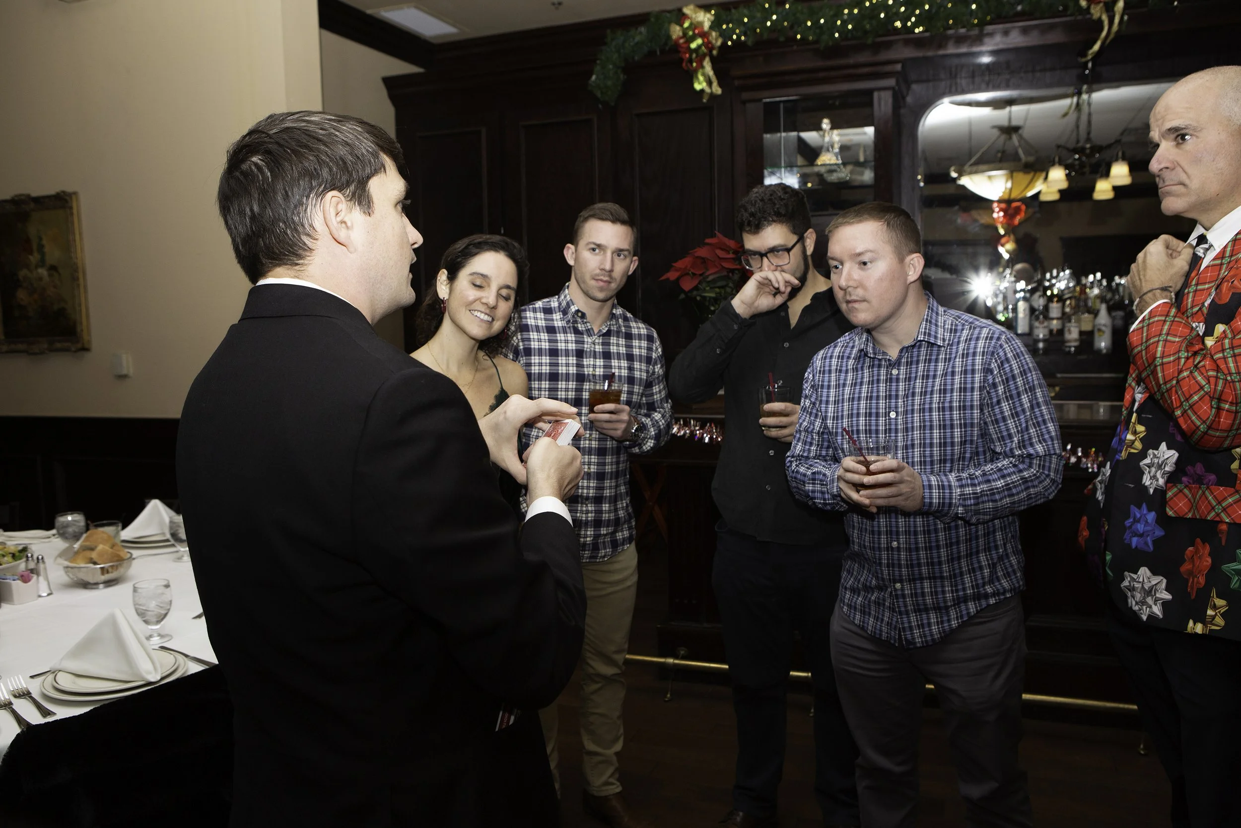 Strolling magician Josh Weidner performing close-up magic for guests at a corporate cocktail hour