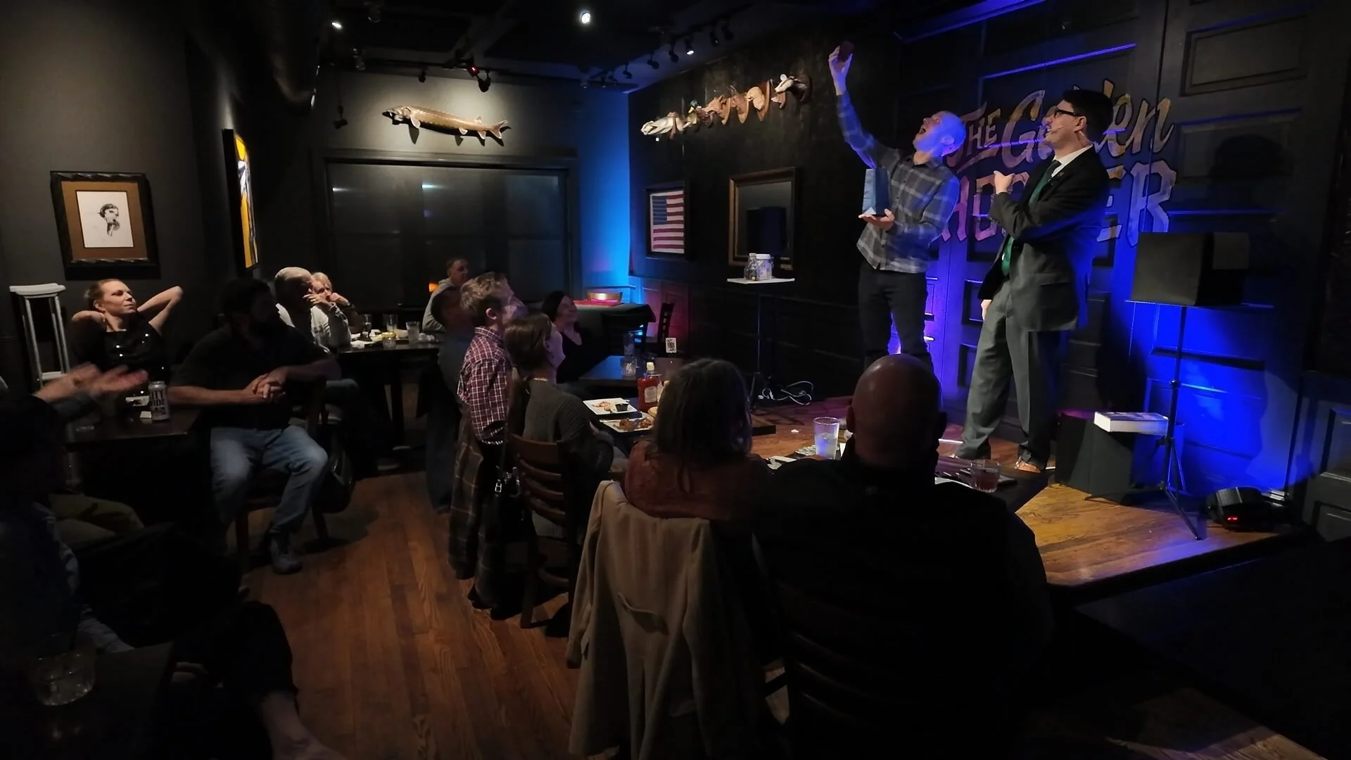 Corporate magician Josh Weidner performing a comedy magic stage show with an audience volunteer