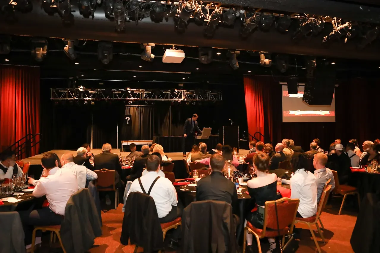 Corporate event guest engagement: magician Josh Weidner interacting with guests at a company event