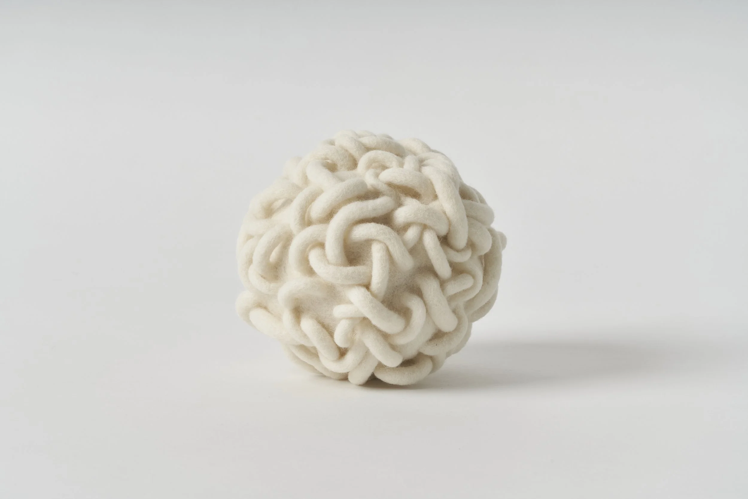 'Entwine', 2025, wool fibre, felt, thread, 16 x 16 x x 16cm. [Private Collection]. Image: Sam Roberts