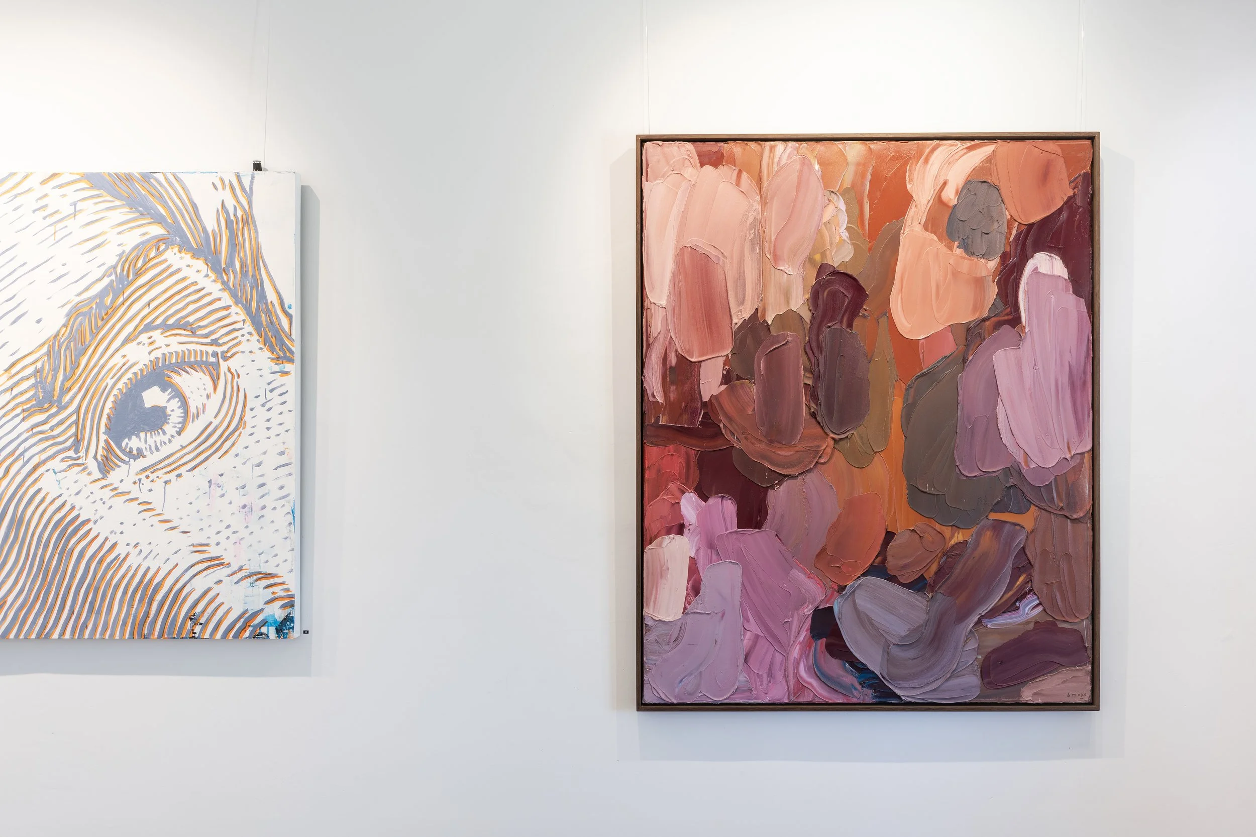 Jason Pevreall and Brooke Stiller artworks, one with a stylized eye design in white and orange, and the other with overlapping brushstrokes of pink, purple, and coral colours.